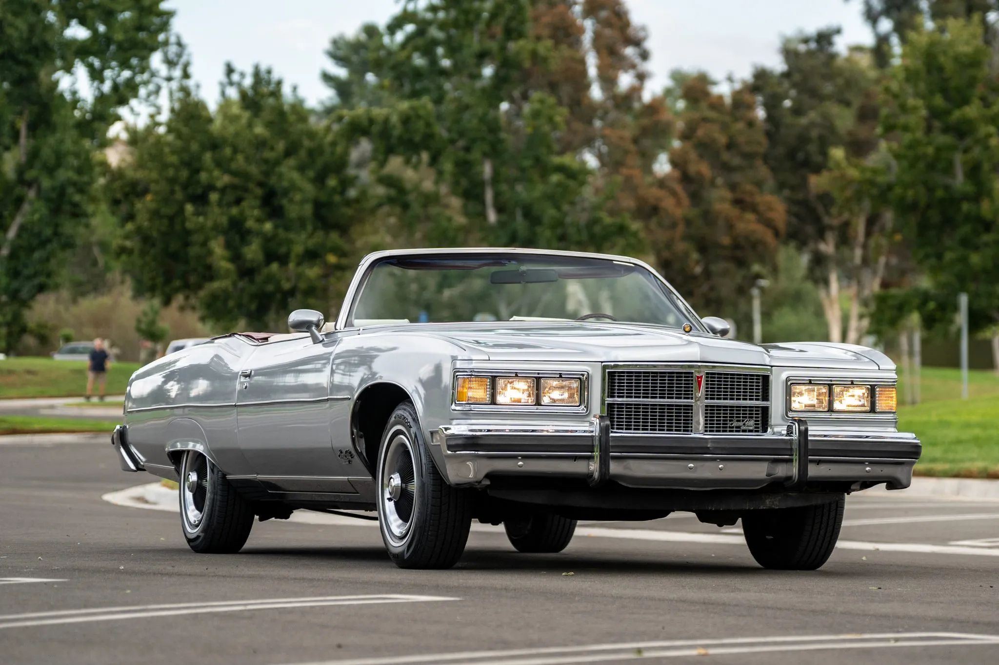 Right front 3q view of a 1975 Pontiac B-body convertible with the headlights on