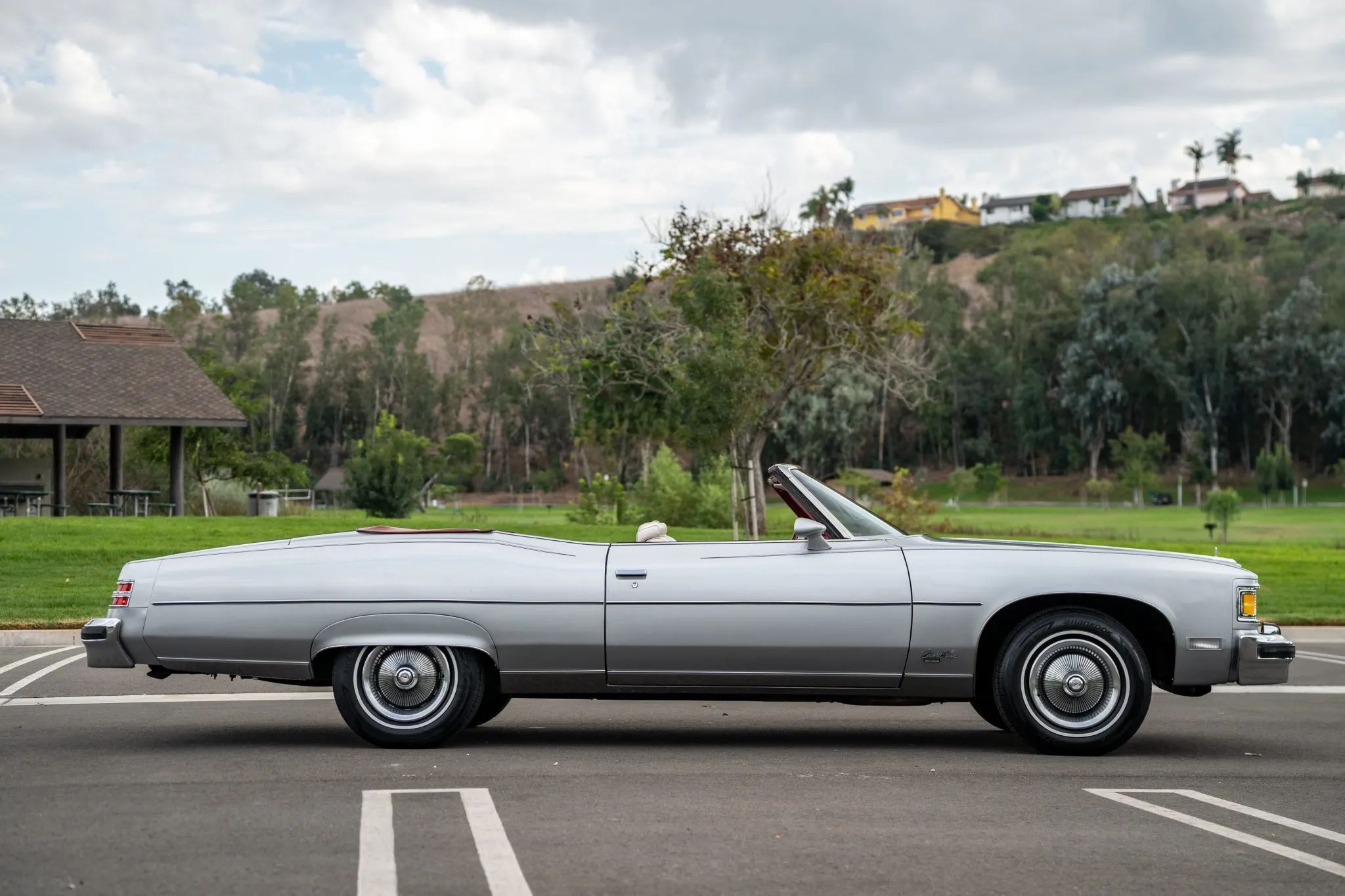 Right side view of a 1975 Pontiac convertible with the top down