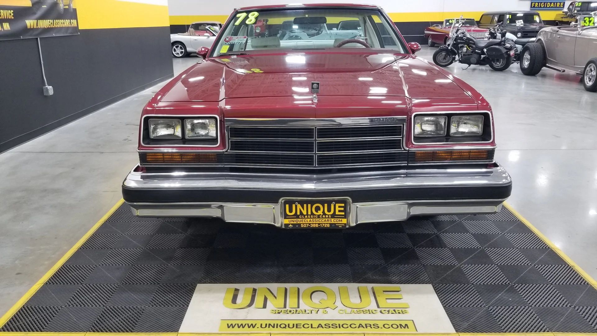 1978 Buick LeSabre Sport Coupe: This Turbo V-6 Was Faster Than A V-8 In The B-Body, But Buyers Weren't Convinced 17 Front view of a 1978 Buick LeSabre coupe in an indoor showroom, with a Unique Classic Cars sign on the floor in front of it