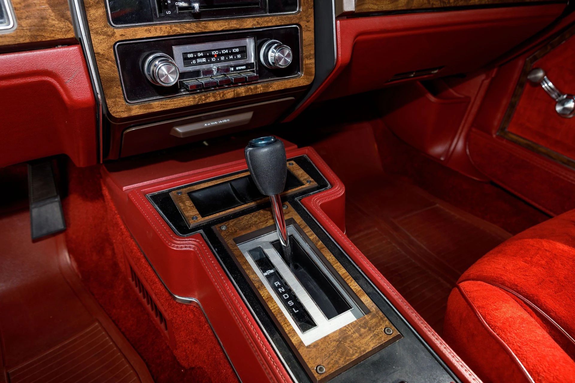 1979 Pontiac Bonneville Coupe: Rare And Plush Bucket Seat B-Body 18 Automatic shifter in a red floor console with woodgrain trim