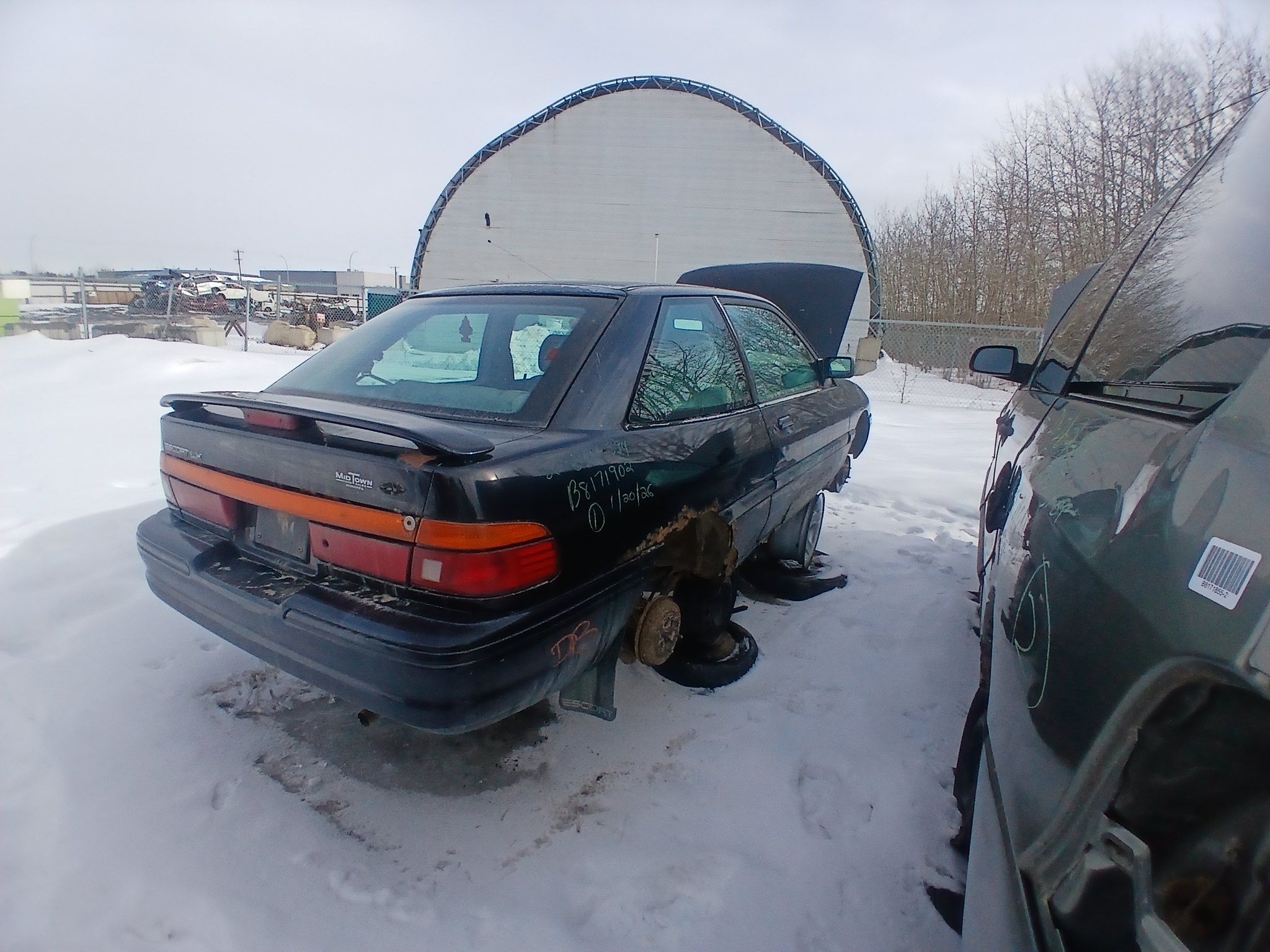Rear three-quarter view of black 1996 Ford Escort hatchback