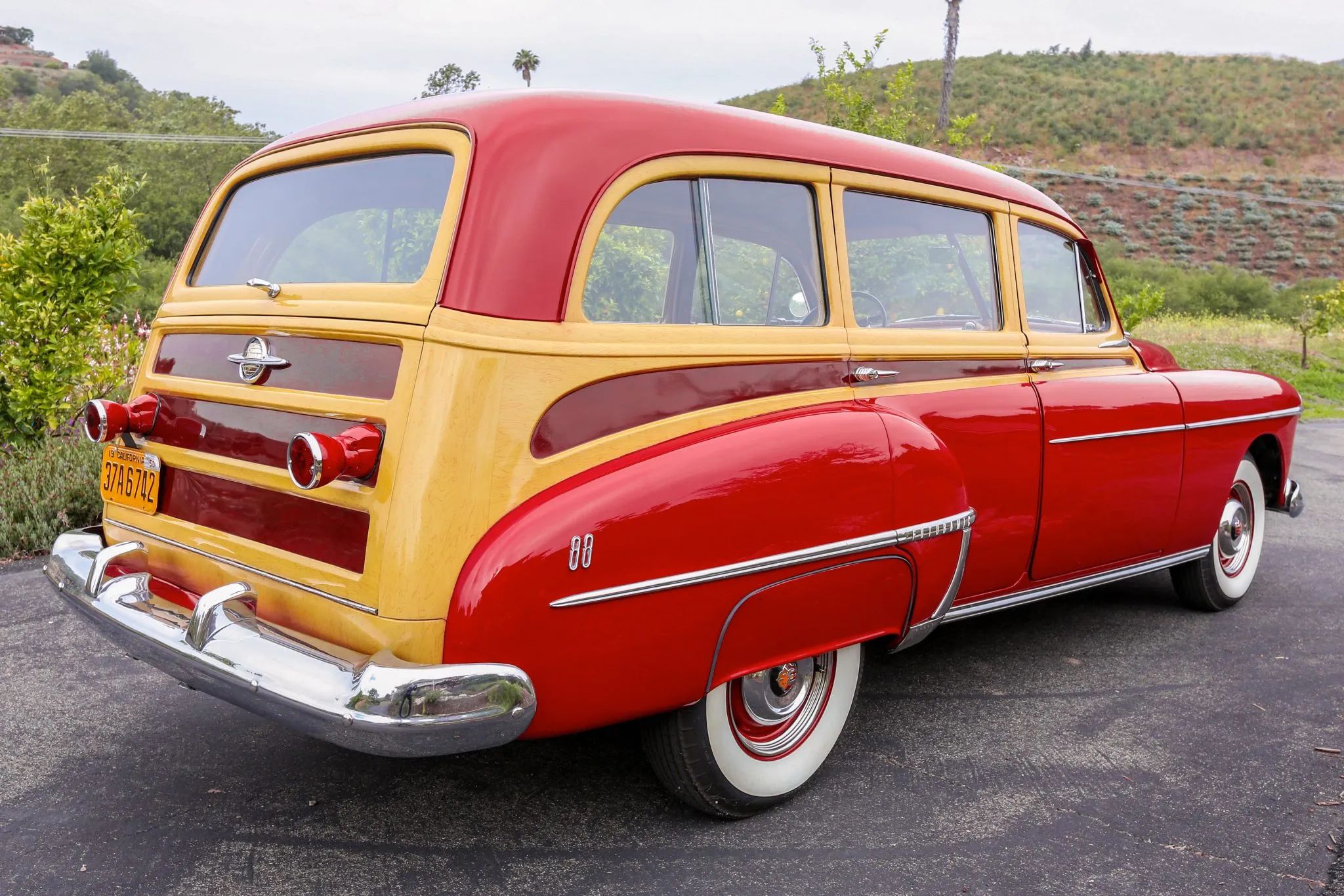 Right rear 3q view of a 1950 Oldsmobile station wagon with fake wood trim