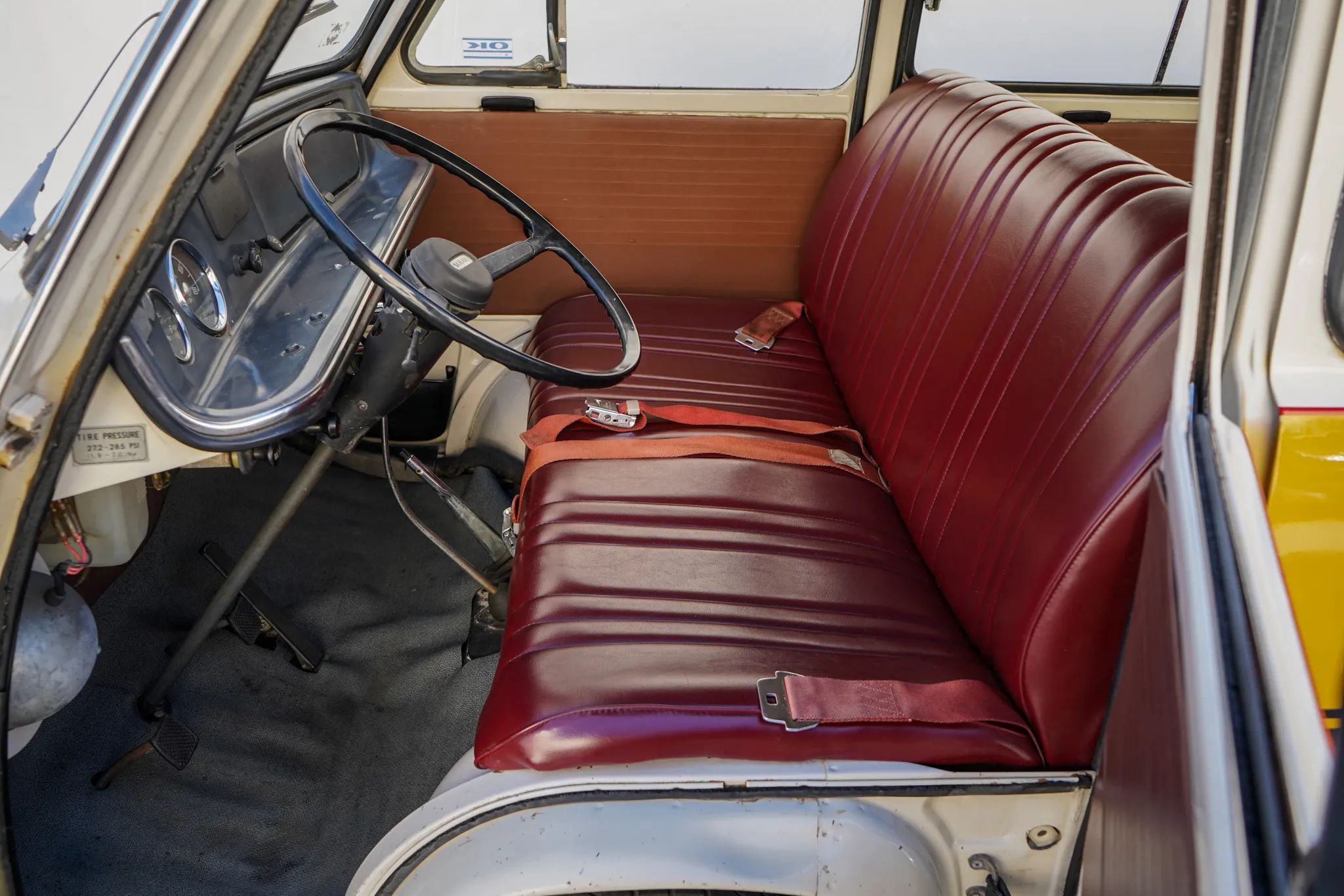 Front seat of a Subaru Sambar van with red vinyl upholstery