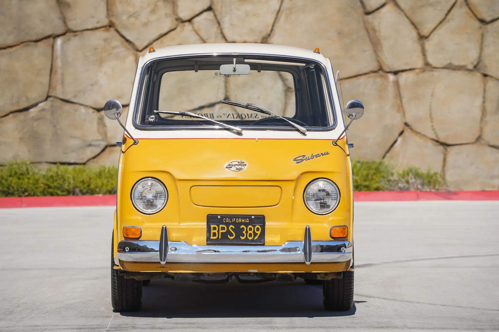 Front view of an orange and white Subaru Sambar keitora van