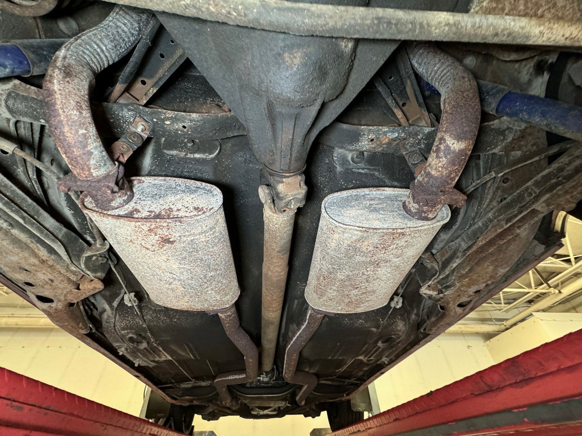 Dual exhausts under a 1973 Oldsmobile