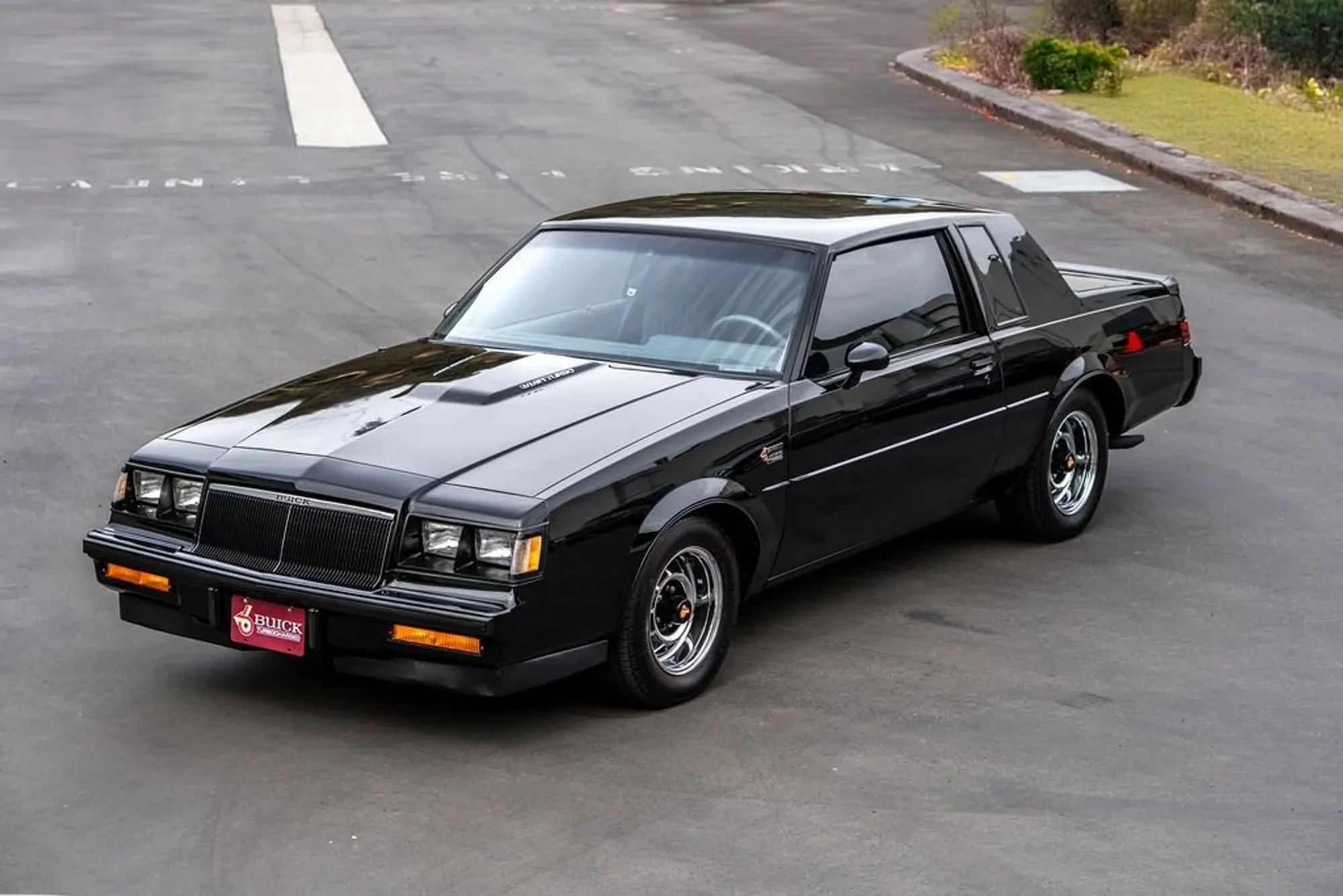 High-angle front 3q view of a black 1986 Buick Regal Grand National coupe