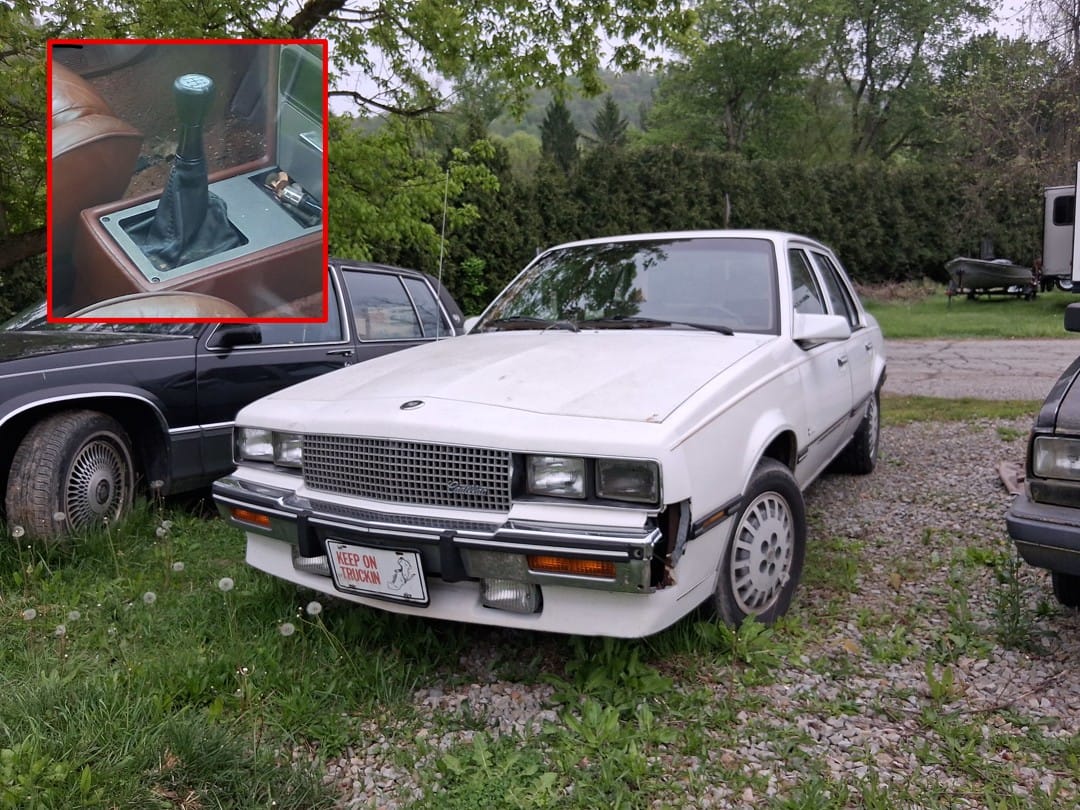 White 1985 Cadillac Cimarron with rare five-speed manual transmission shown from driver's front three-quarter view