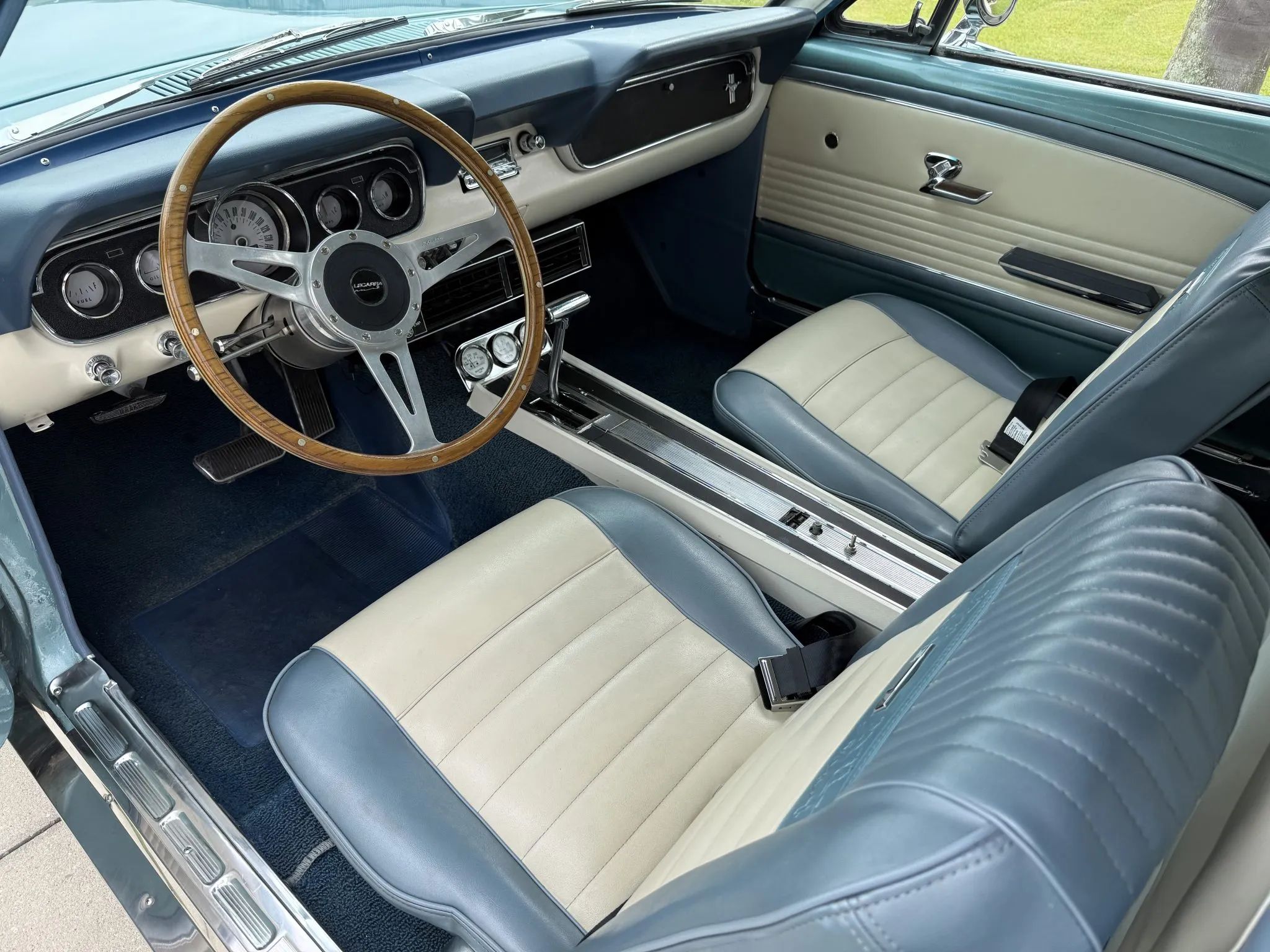 1966 Ford Mustang Limousine Conversion And A Possible (New) Mustang Sedan: Stretching An Idea Too Far 16 Dashboard and front seats of a 1966 Ford Mustang with blue-and-white Pony interior, center console, aftermarket wheels, and aftermarket console gauges
