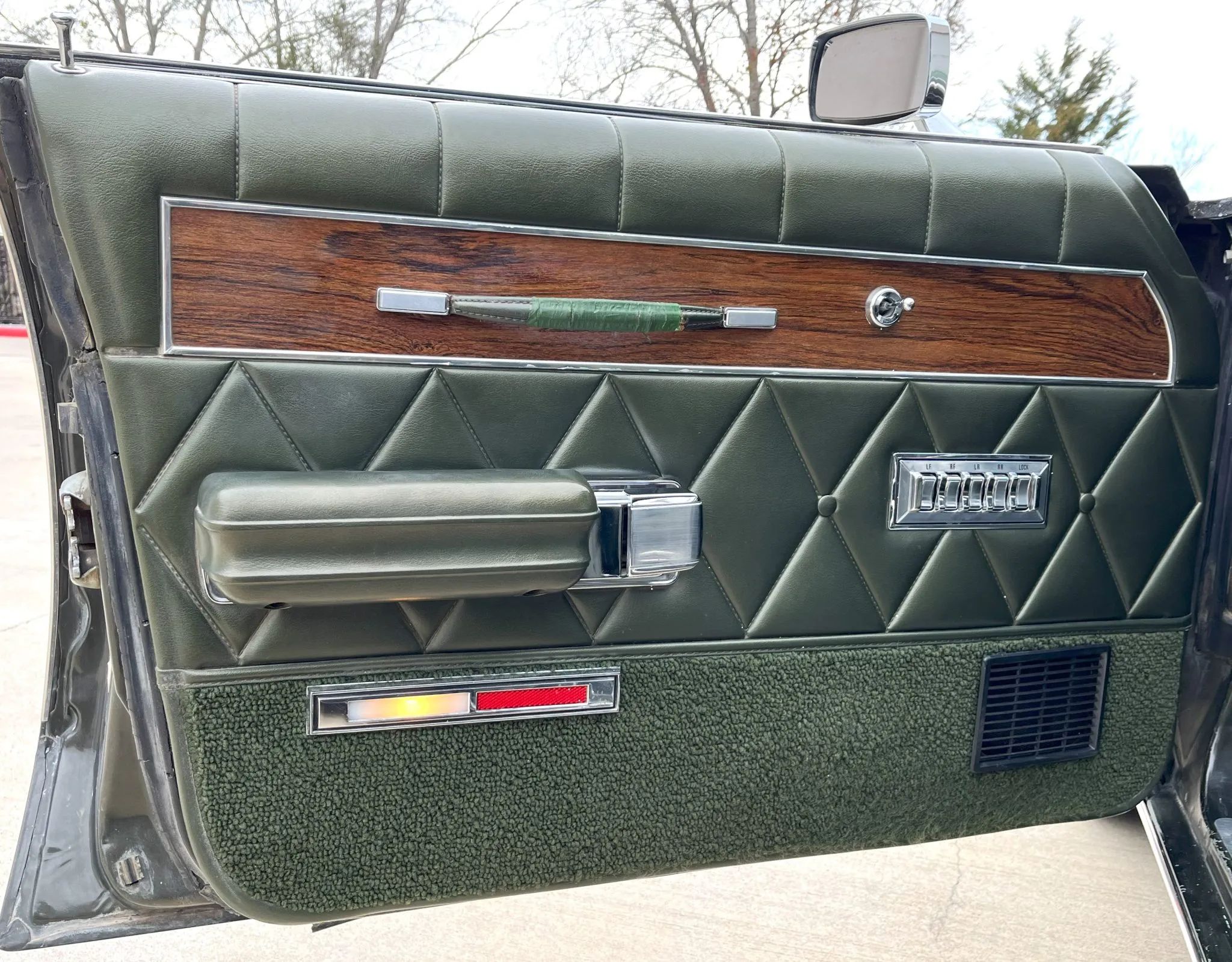 1970 Mercury Marquis Brougham Four-Door Hardtop: The Budget Continental 9 Driver's door trim of a 1970 Mercury Marquis Brougham, with a strip of green tape on the door pull
