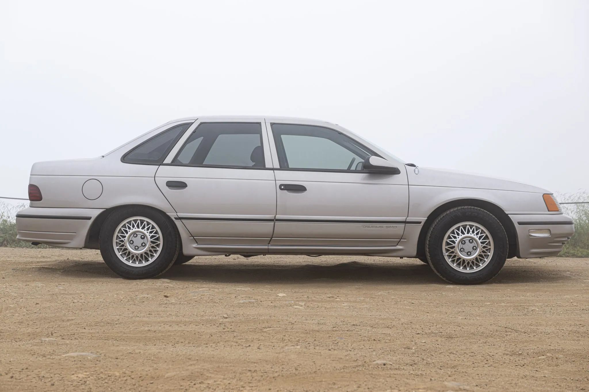 Right side view of a Light Titanium 1989 Ford Taurus SHO sedan