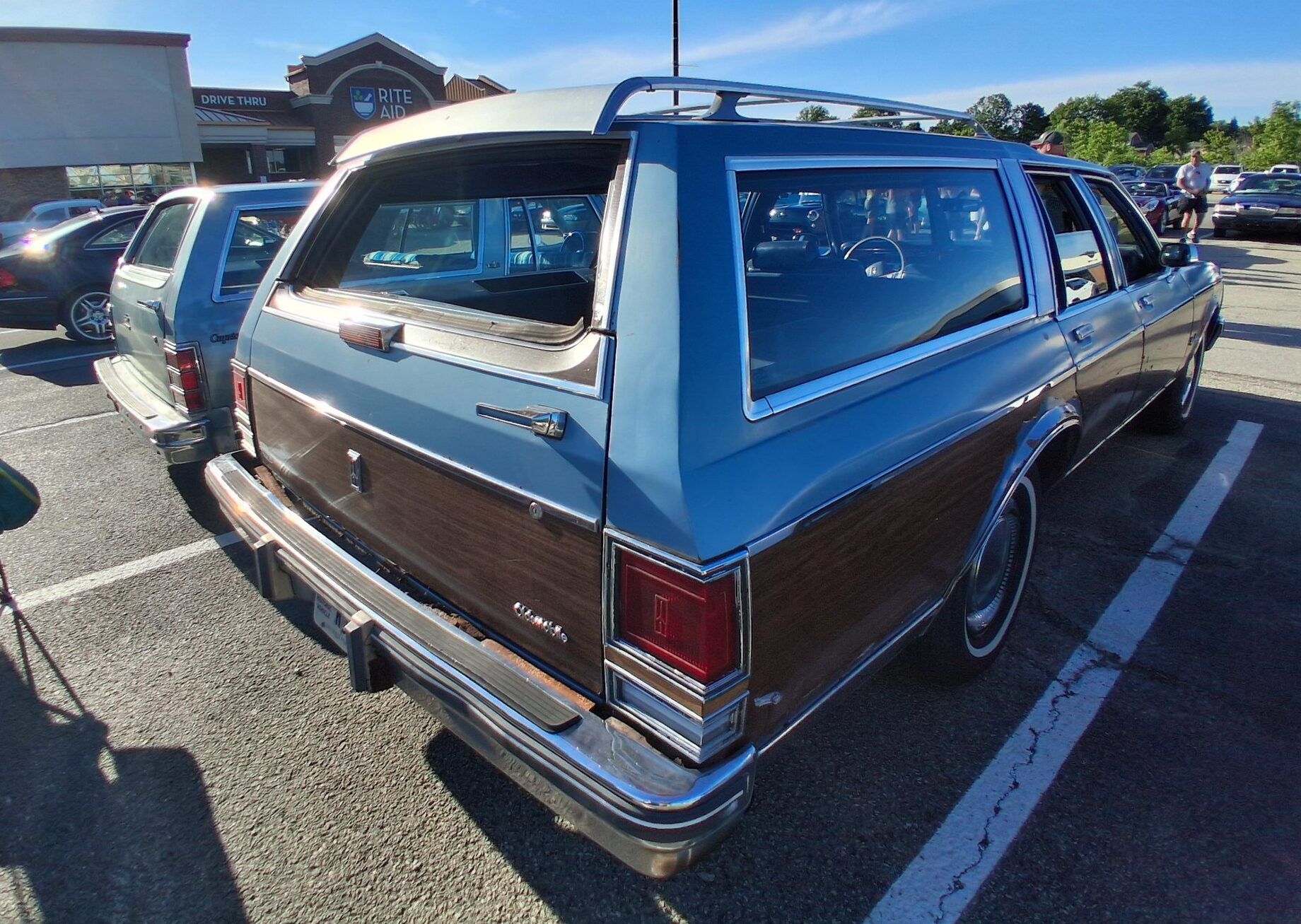Passenger rear three-quarter view of blue Oldsmobile Custom Cruiser