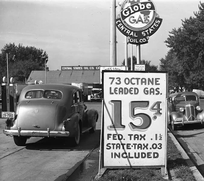 1949 Oldsmobile Rocket V-8 And The Ultra-High-Compression Economy Version That Never Made It 4 Vintage B&W photo of a Globe Gas Central States Oil Company gas station with two '30s cars and a sign reading "73 octane leaded gas. 15.4 Fed. tax .1½ State tax .03 included