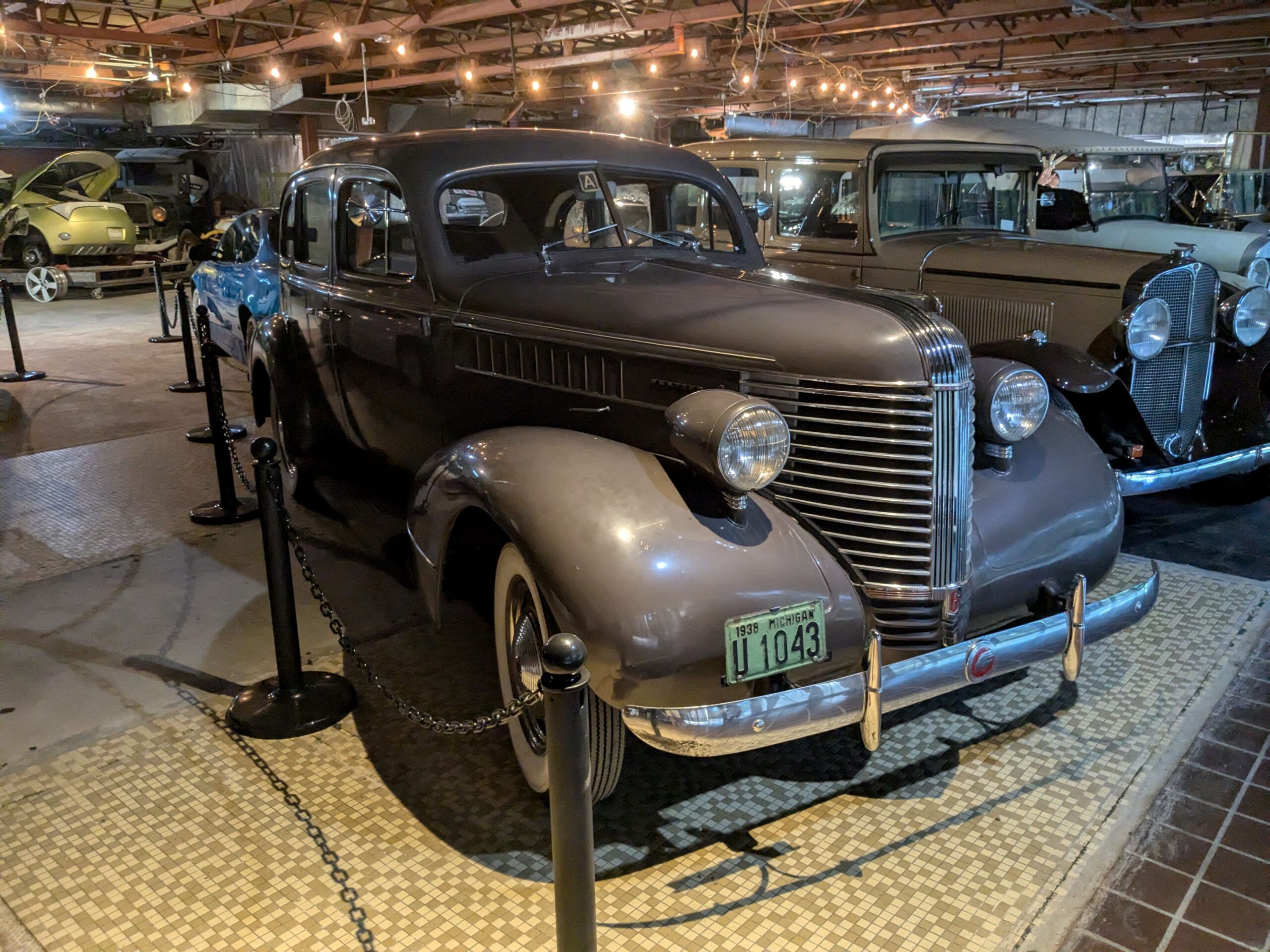 1938 Pontiac Deluxe Six Touring Sedan: Motoring The Way It Used To Be 3 Passenger three-quarter view of gray 1938 Pontiac Sedan in a museum setting