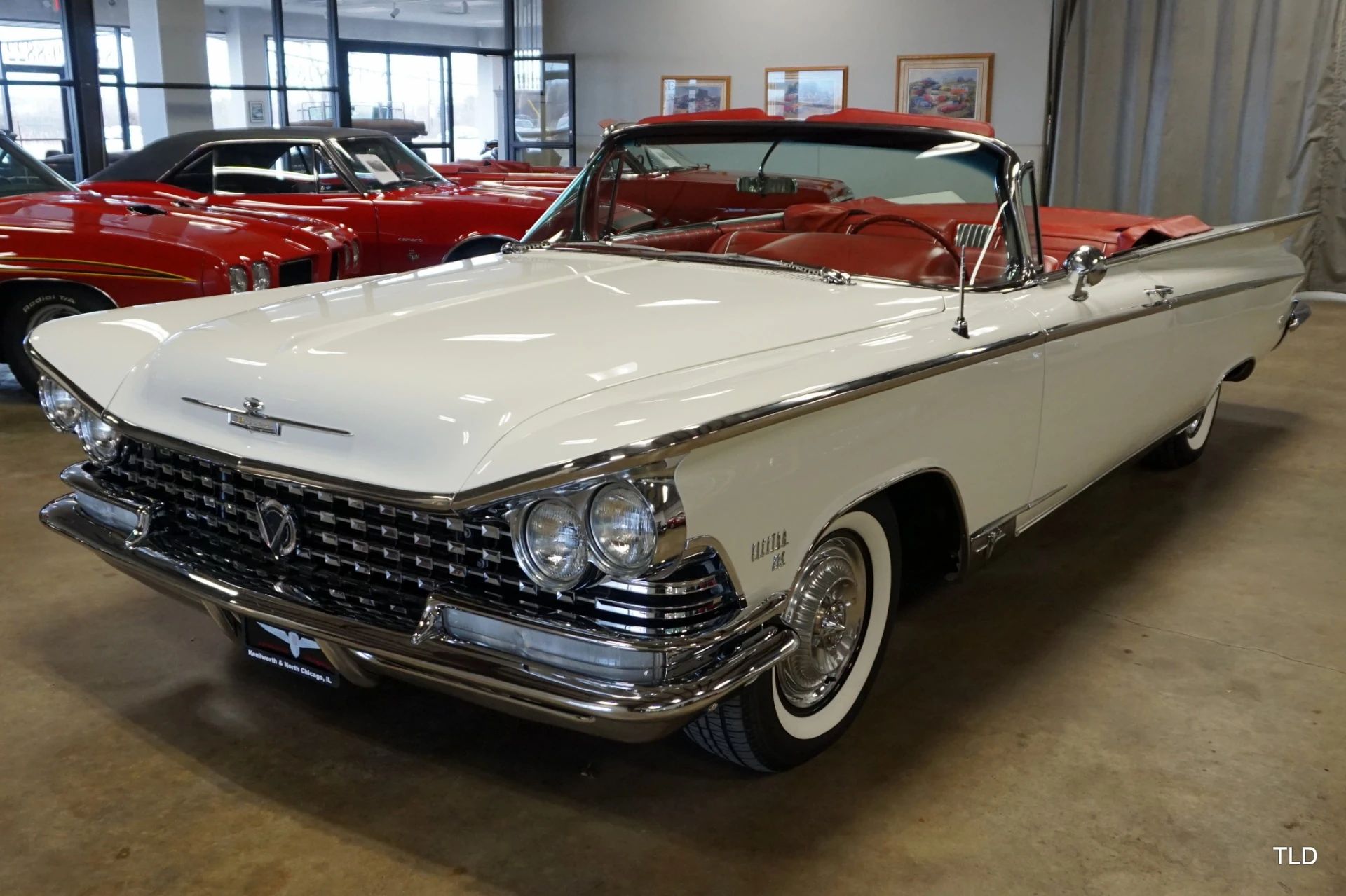 Left front 3q view of a 1959 Buick convertible in an indoor showroom