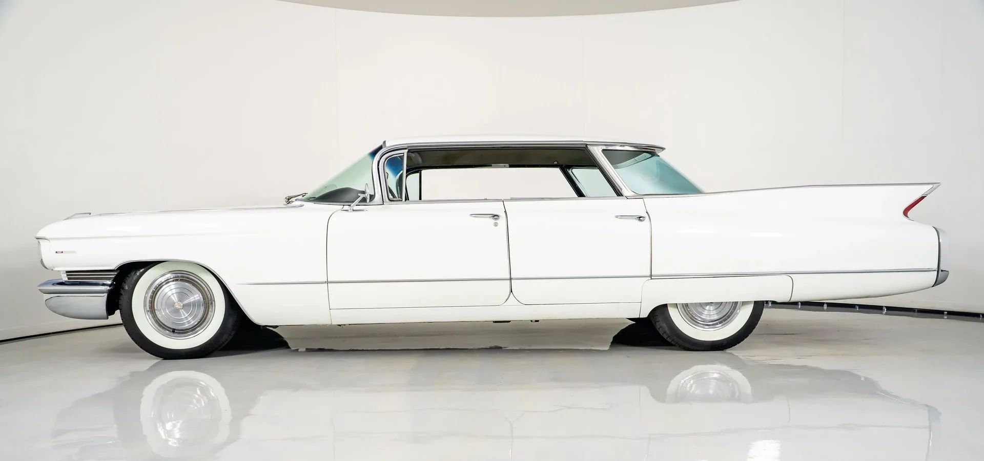 Left side view of a 1960 Cadillac flattop four-door hardtop in an interior studio