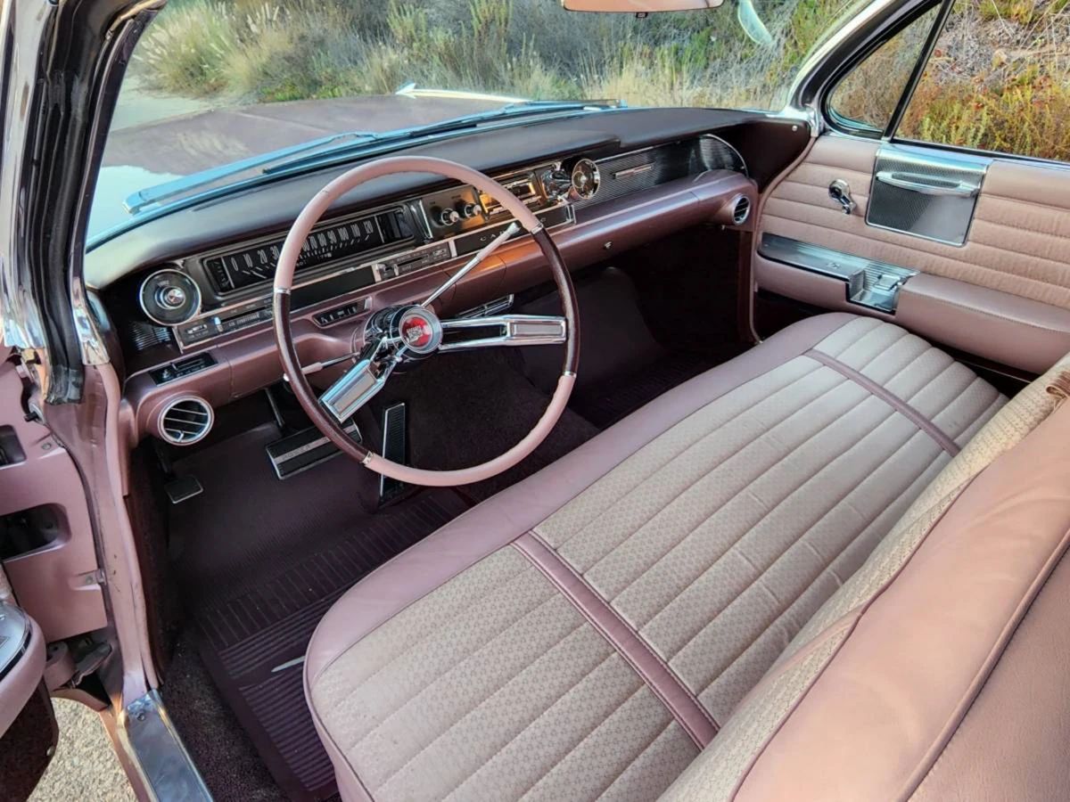 Front seat and dashboard of a 1961 Cadillac, seen from the left