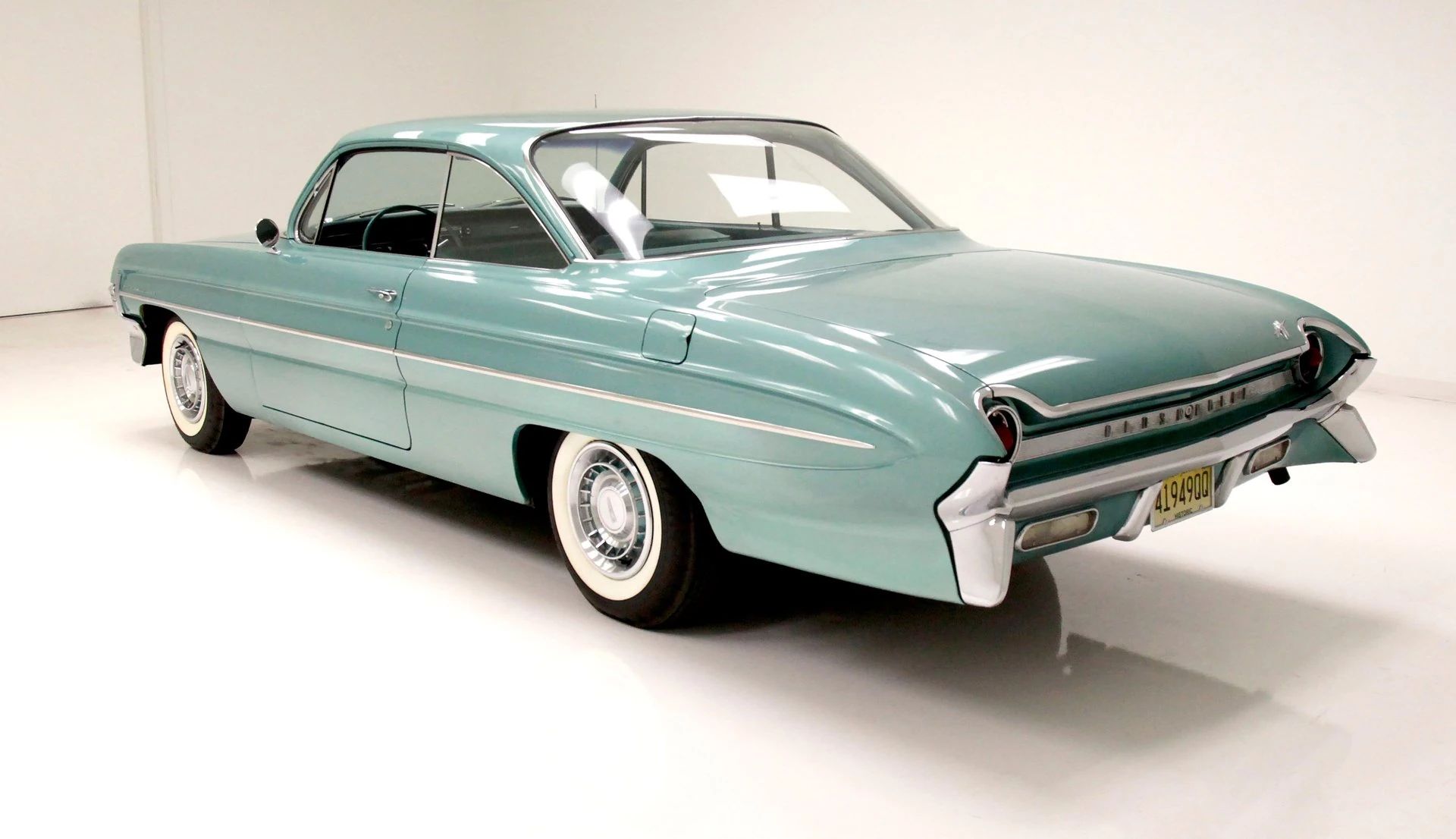 1962 Oldsmobile Ninety-Eight Holiday Coupe: A Sharper-Edged Roof Squares Off The Bubbletop 5 Left rear 3q view of a 1961 Oldsmobile 88 two-door hardtop in an indoor studio space
