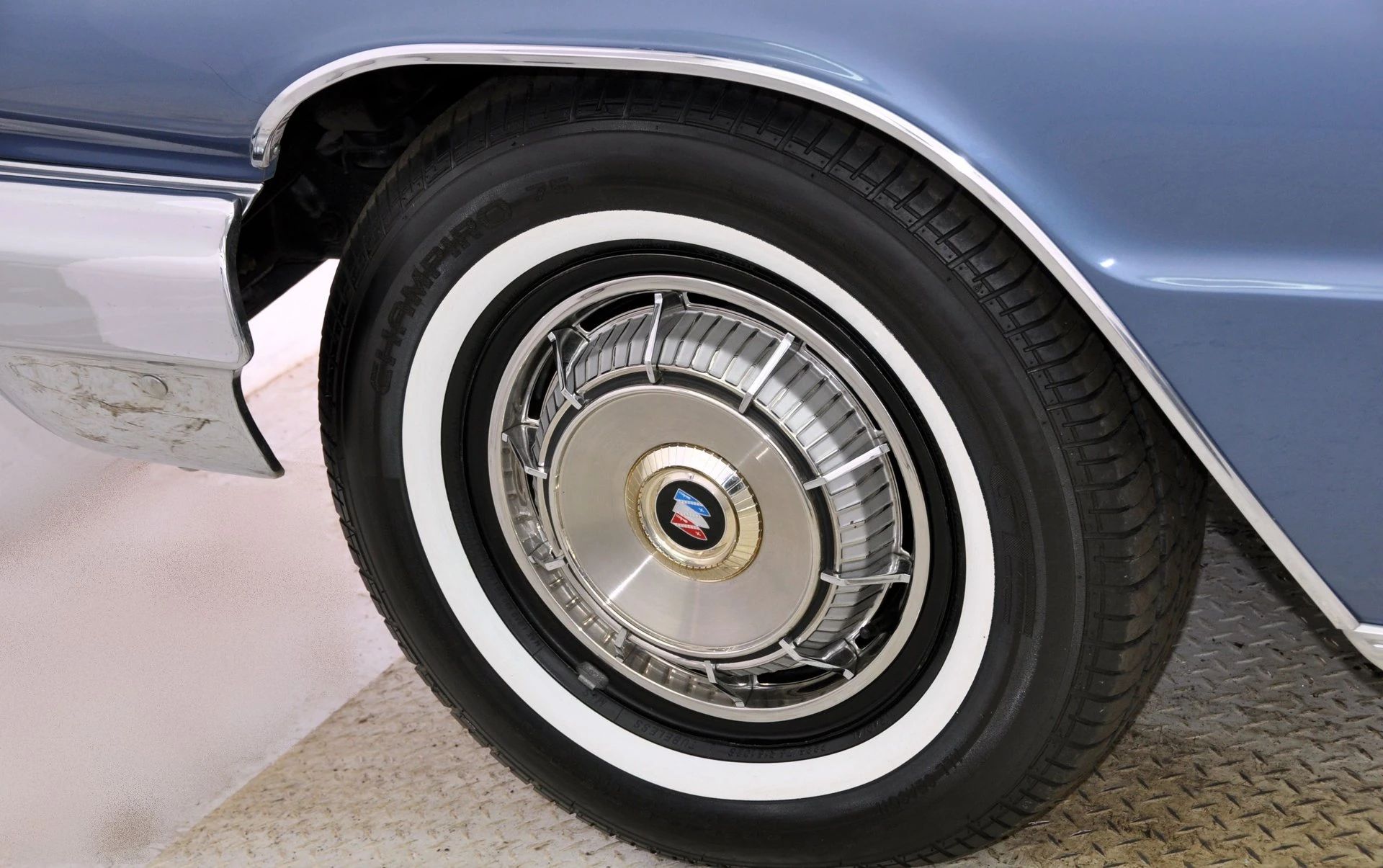 Whitewall tire and wheel cover of a 1962 Buick