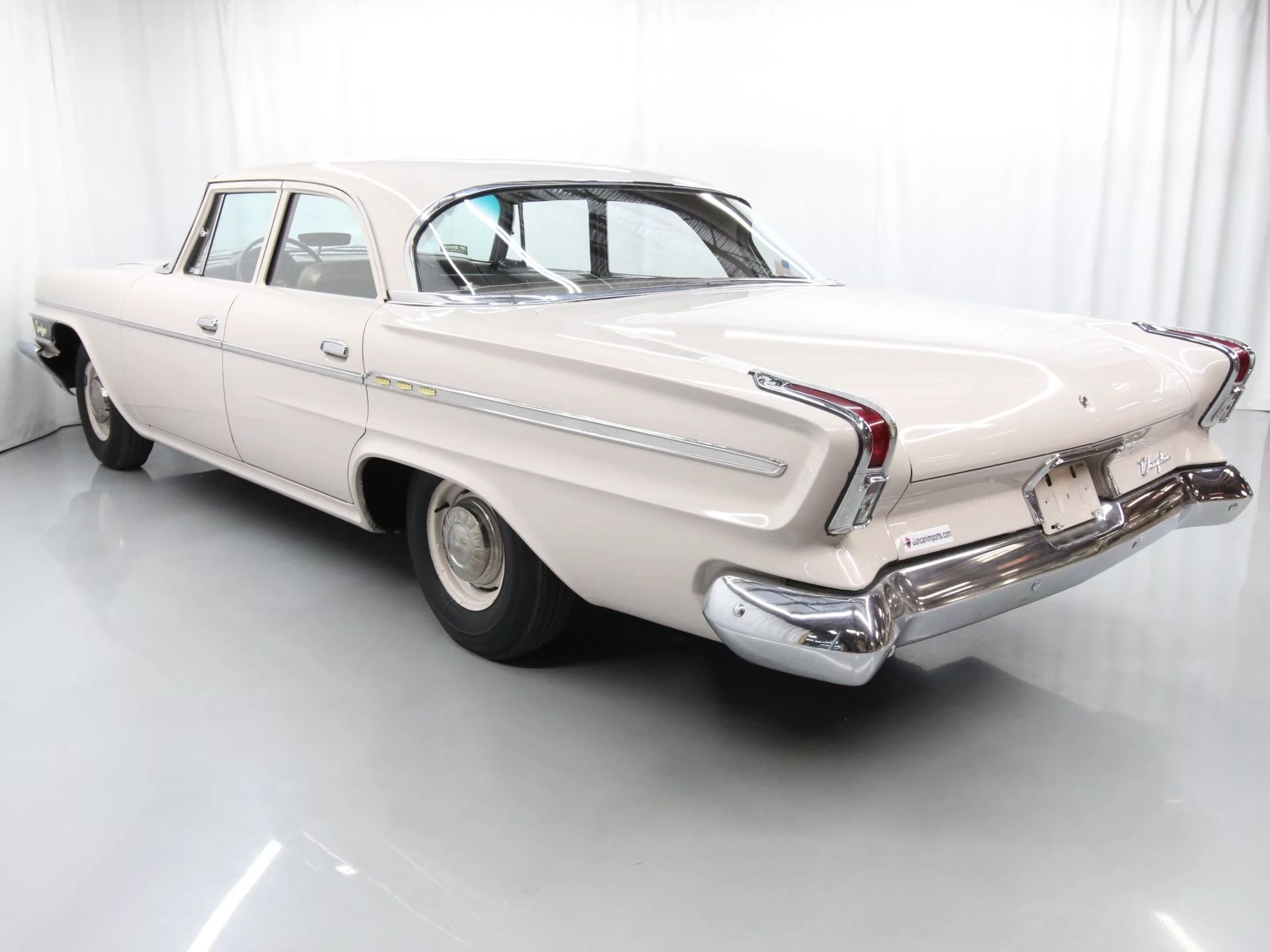 1962 Chrysler Newport 3-Speed Four-Door Sedan: Basic Big Car With An Upscale Badge And Not Much Else 11 Left rear 3q view of a 1962 Chrysler four-door sedan in an indoor studio space