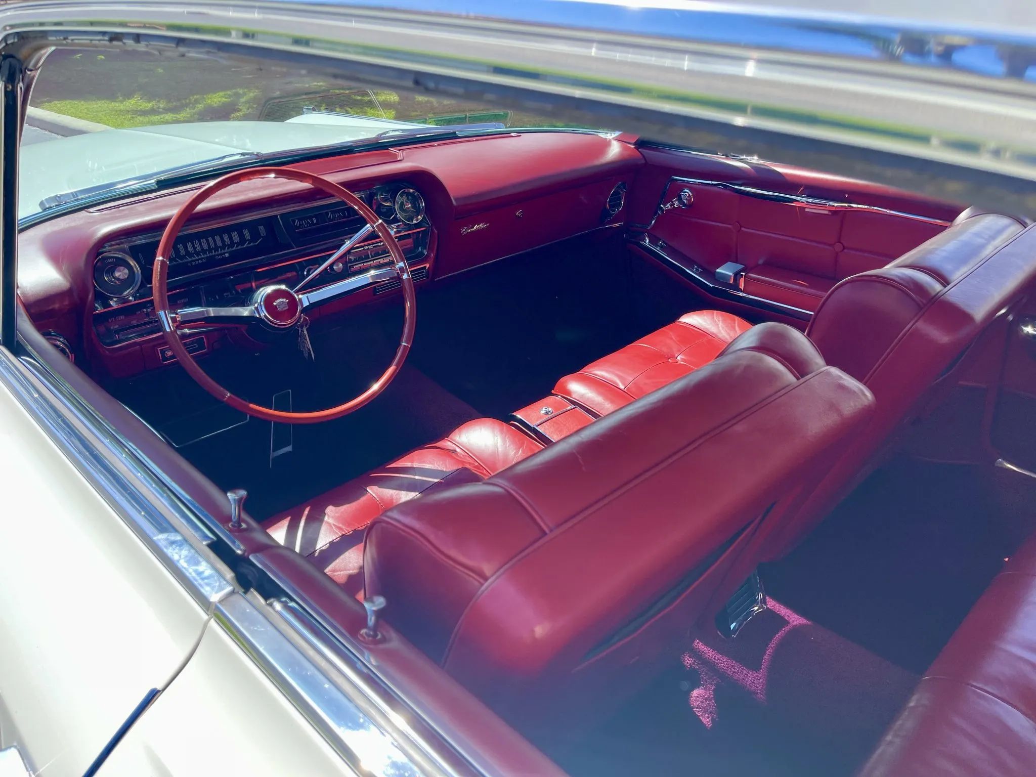 Interior of a 1963 Cadillac four-door hardtop, seen through the left rear window opening with all the side windows down