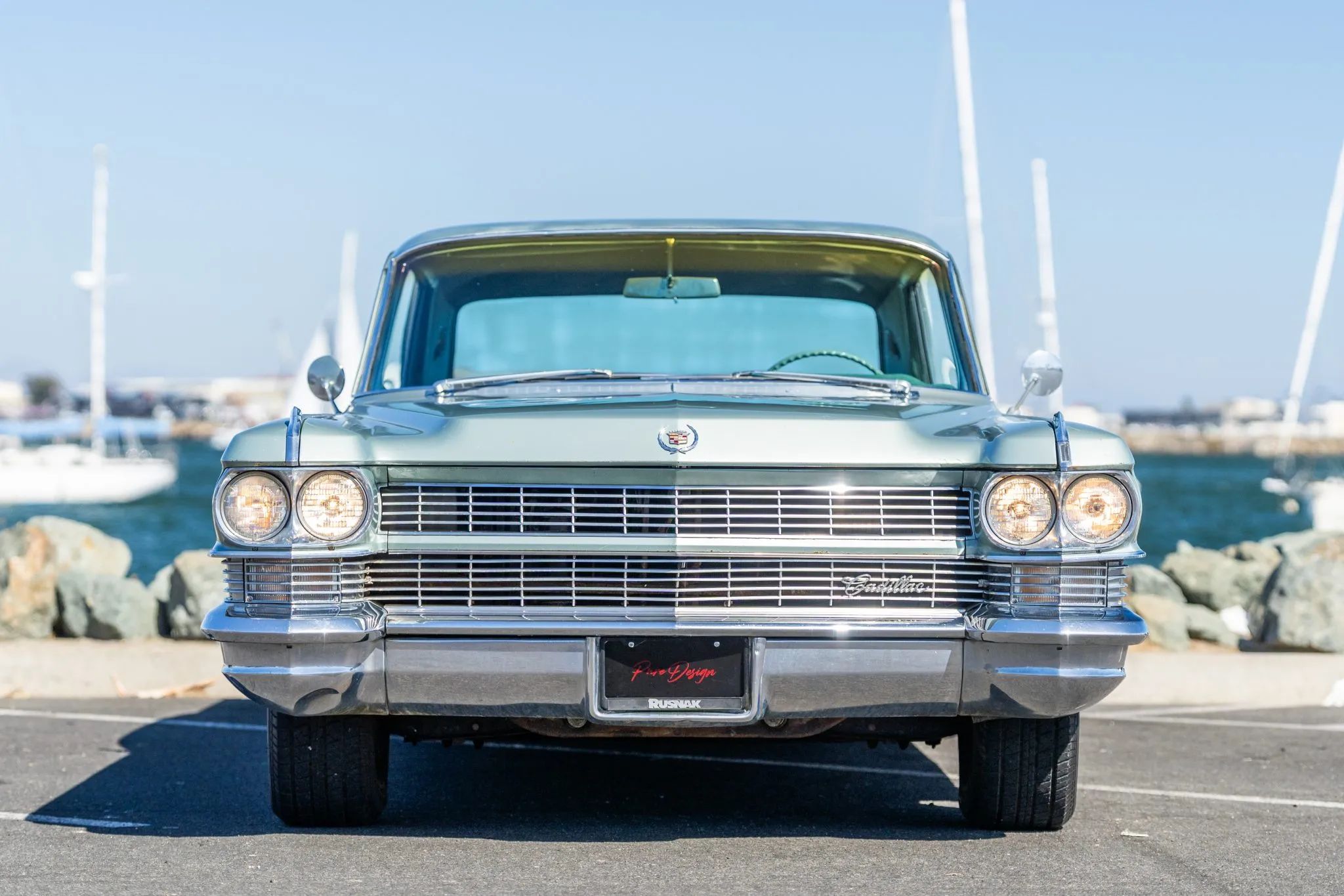 Front view of a 1964 Cadillac with its headlights on