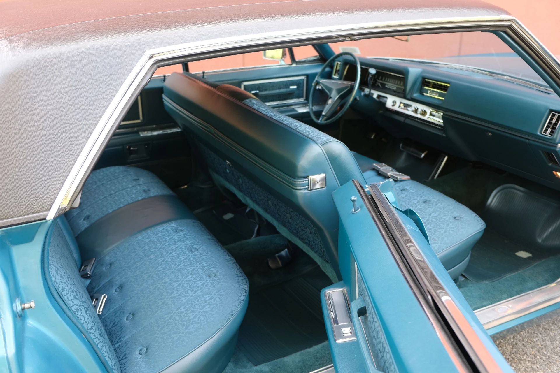 Right side of a 1968 Cadillac four-door hardtop with the side windows down and both doors open