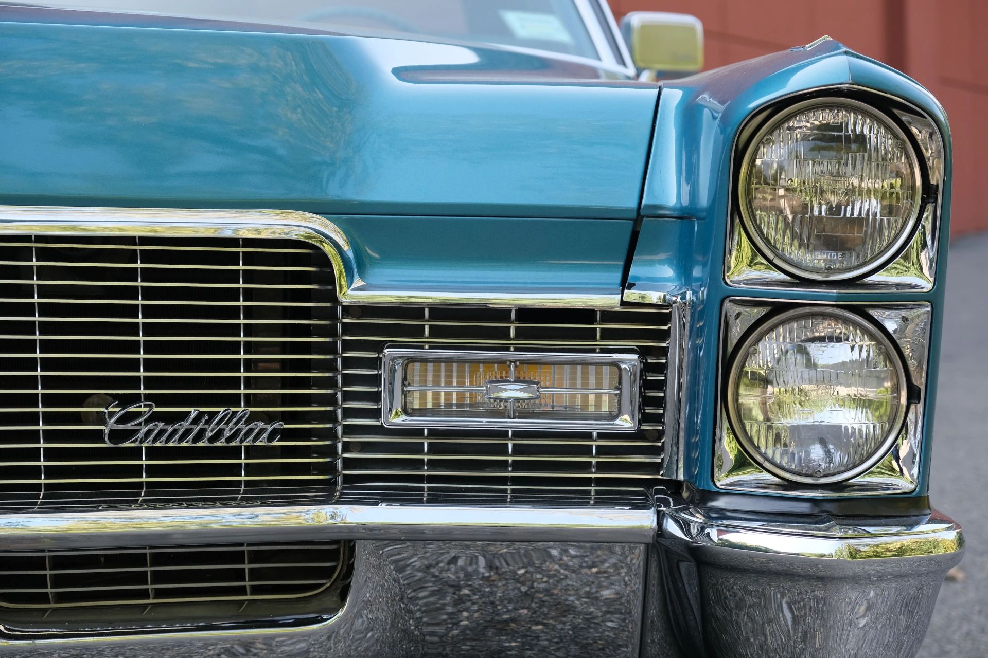 Closeup of the left headlights and grille of a 1968 Cadillac