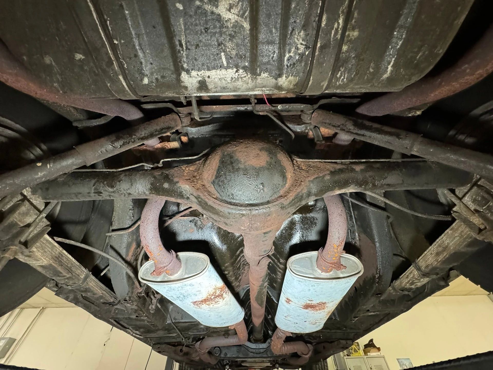 Rear axle and dual exhausts under a 1970 Chrysler