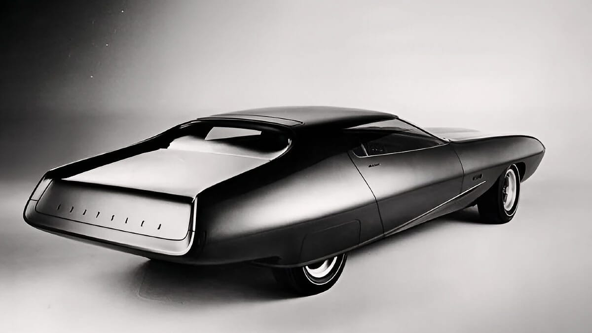 B&W photo showing the rear 3q view of a low-slung concept car