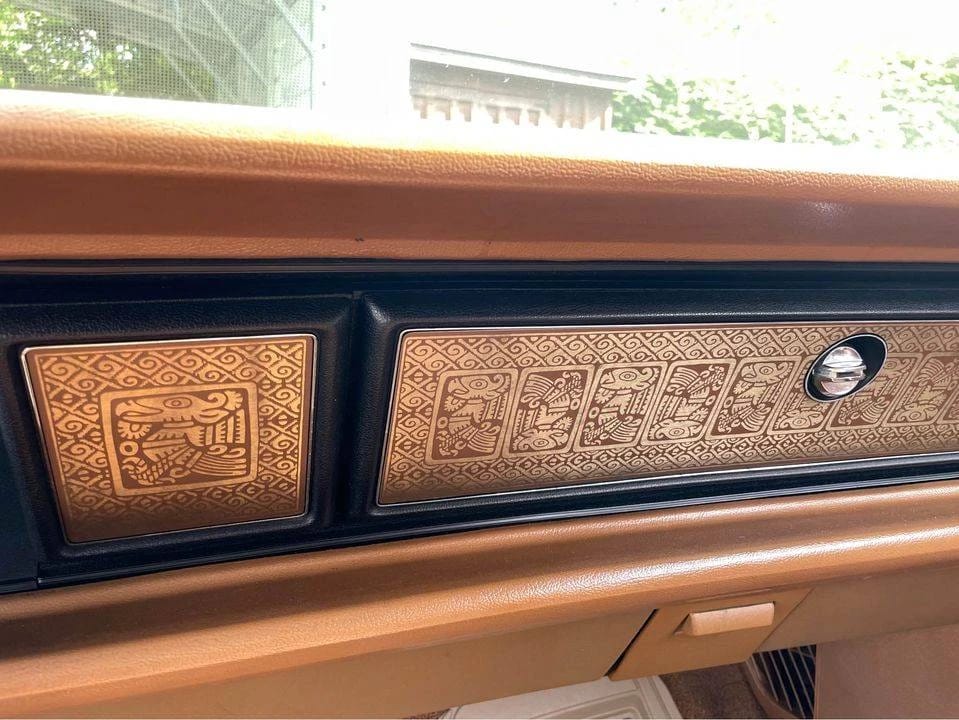Aztec Eagle motif plates on the right side of the dashboard of a 1970 Chrysler