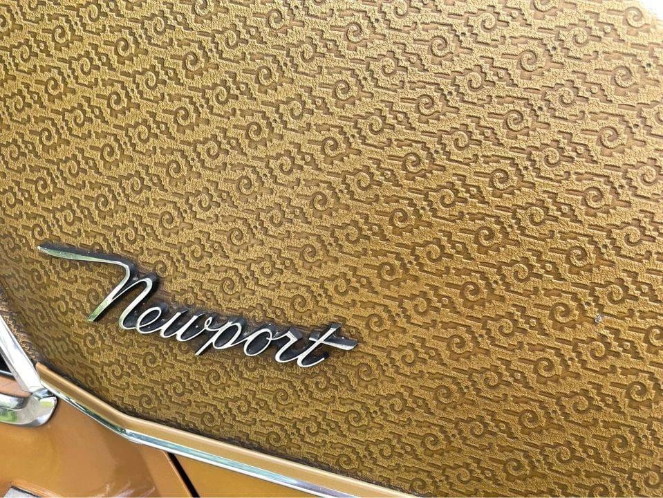 Closeup of the "Newport" badge on a vinyl roof embossed with an intricate design