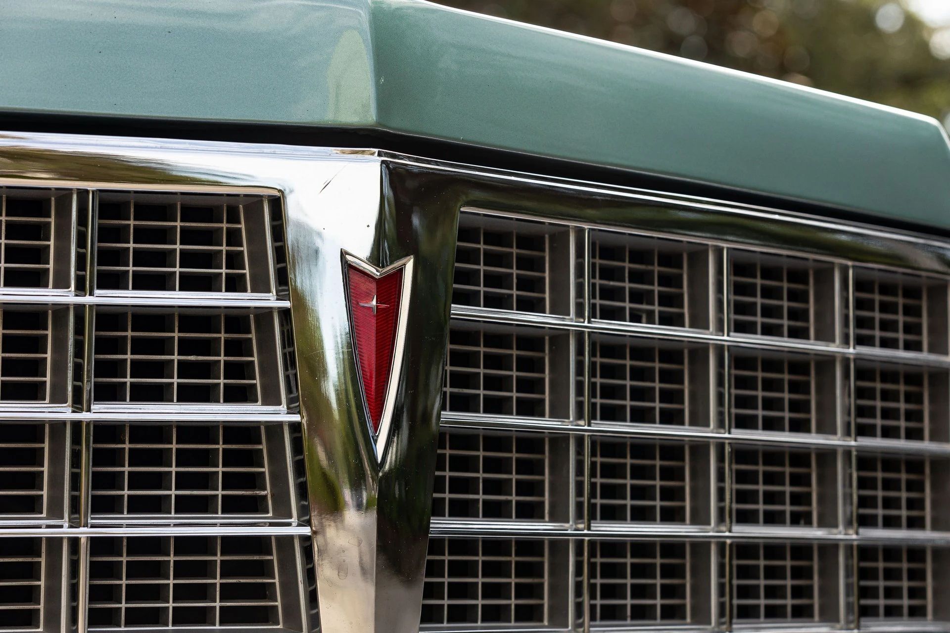 Closeup of the grille and emblem of a 1977 Pontiac