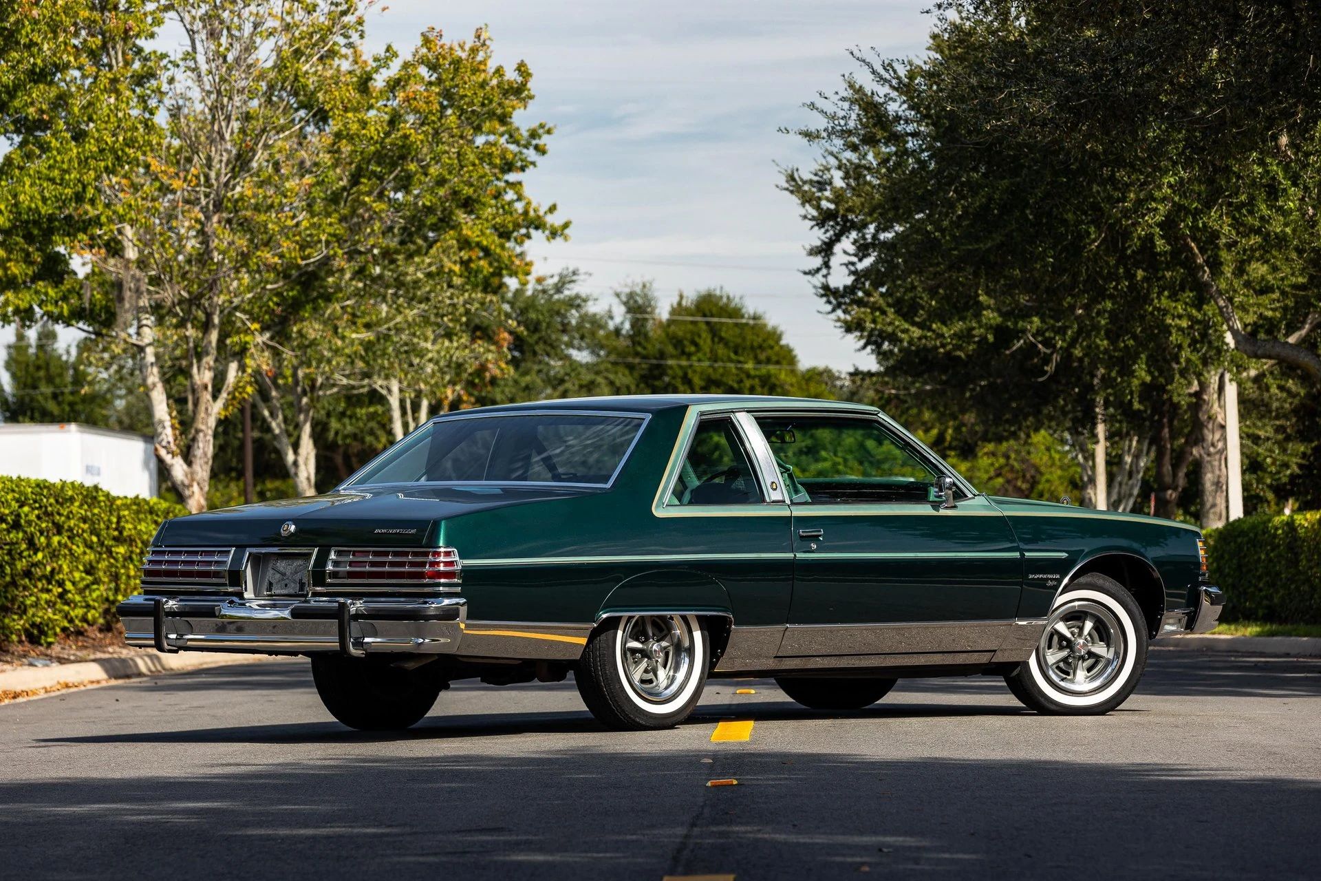 Right rear 3q view of a 1977 Pontiac two-door coupe parked diagonally in the middle of a street