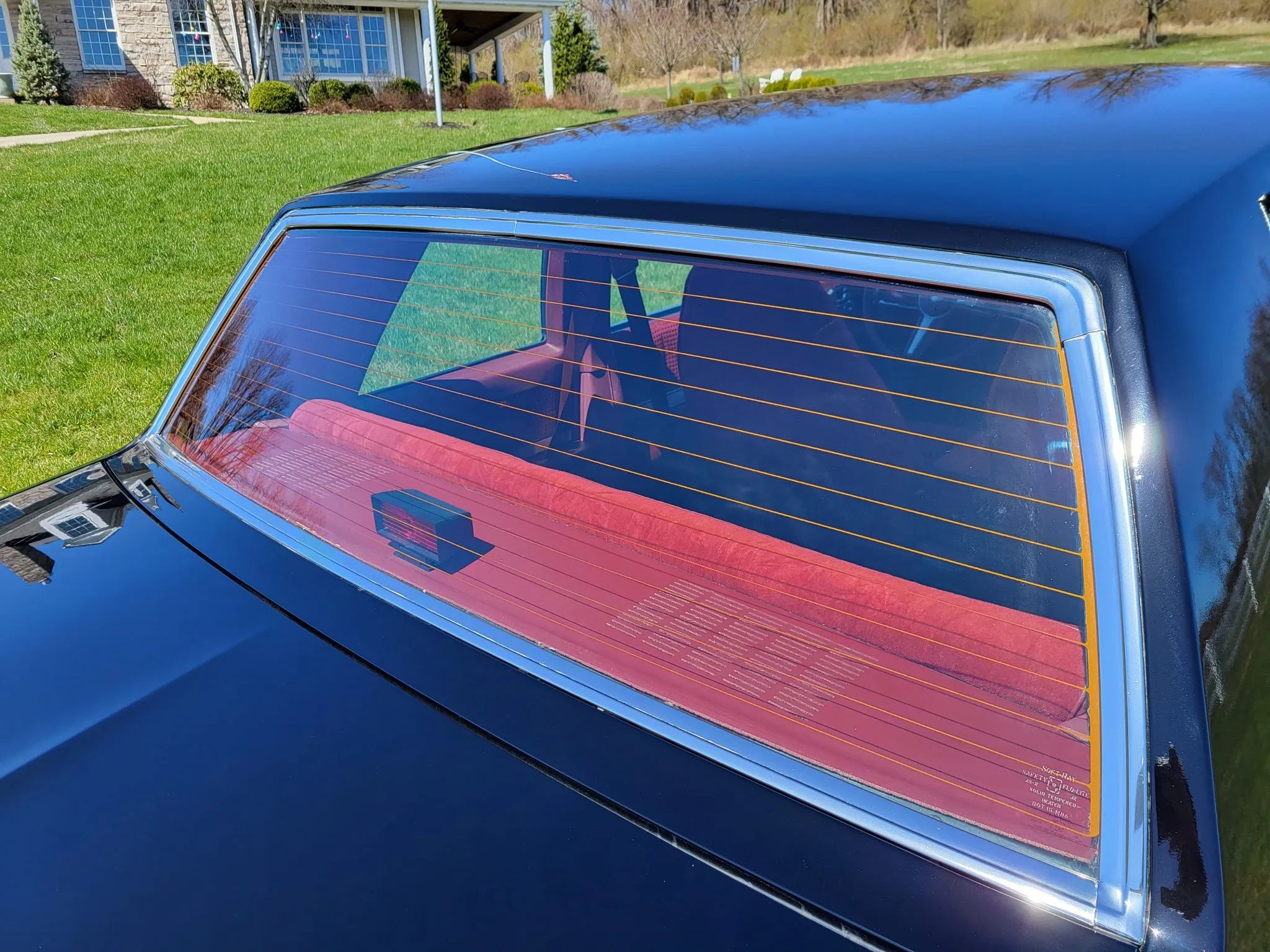1980 Pontiac Phoenix LJ Coupe: Two Doors, Four Speeds, 32,349 Miles, Zero Credibility 8 Back window of a black 1980 Phoenix, with a retrofitted CHMSL ont he rear package shelf