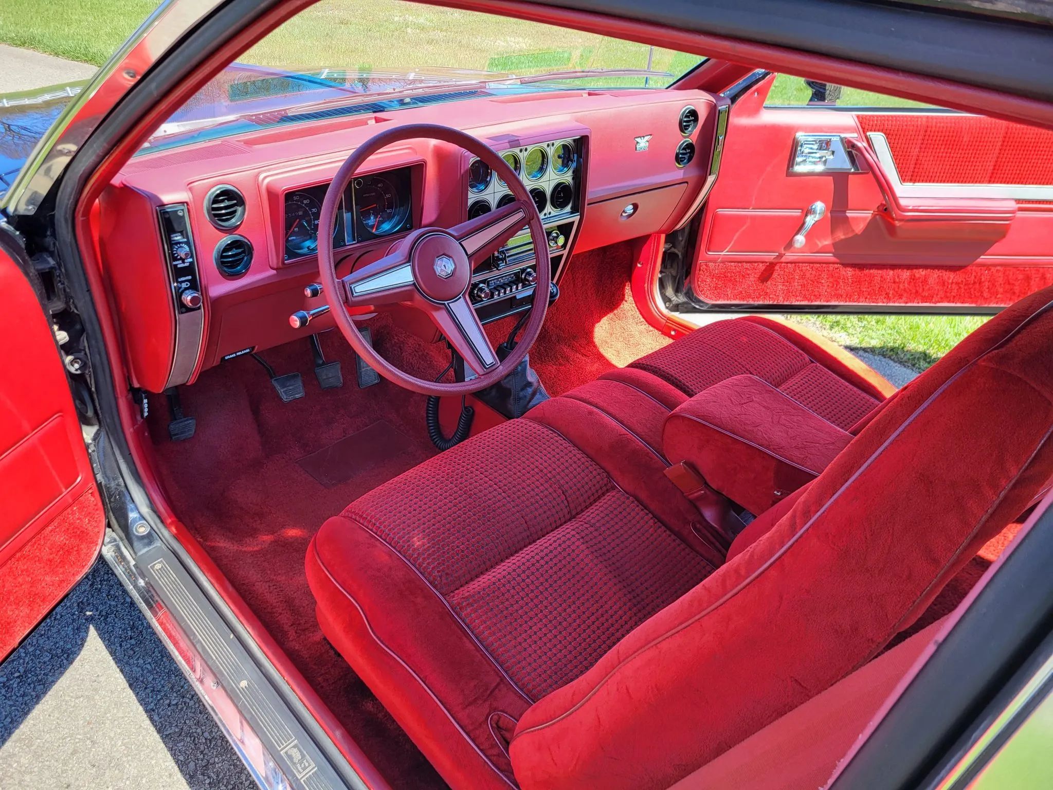 1980 Pontiac Phoenix LJ Coupe: Two Doors, Four Speeds, 32,349 Miles, Zero Credibility 14 Dashboard and front seat of a 1980 Pontiac Phoenix notchback coupe, seen through the driver's door