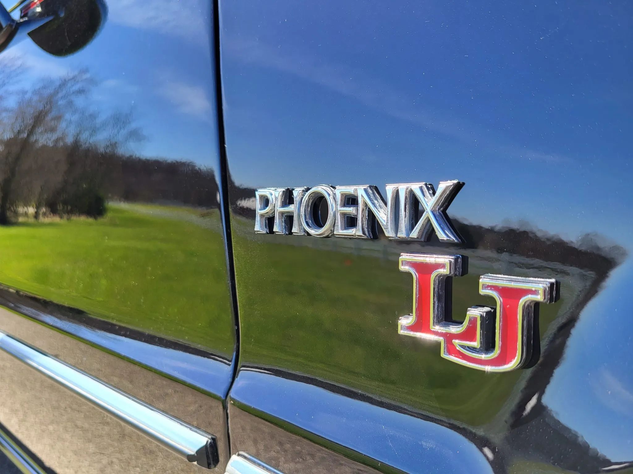 1980 Pontiac Phoenix LJ Coupe: Two Doors, Four Speeds, 32,349 Miles, Zero Credibility 25 "Phoenix LJ" badge on a black car
