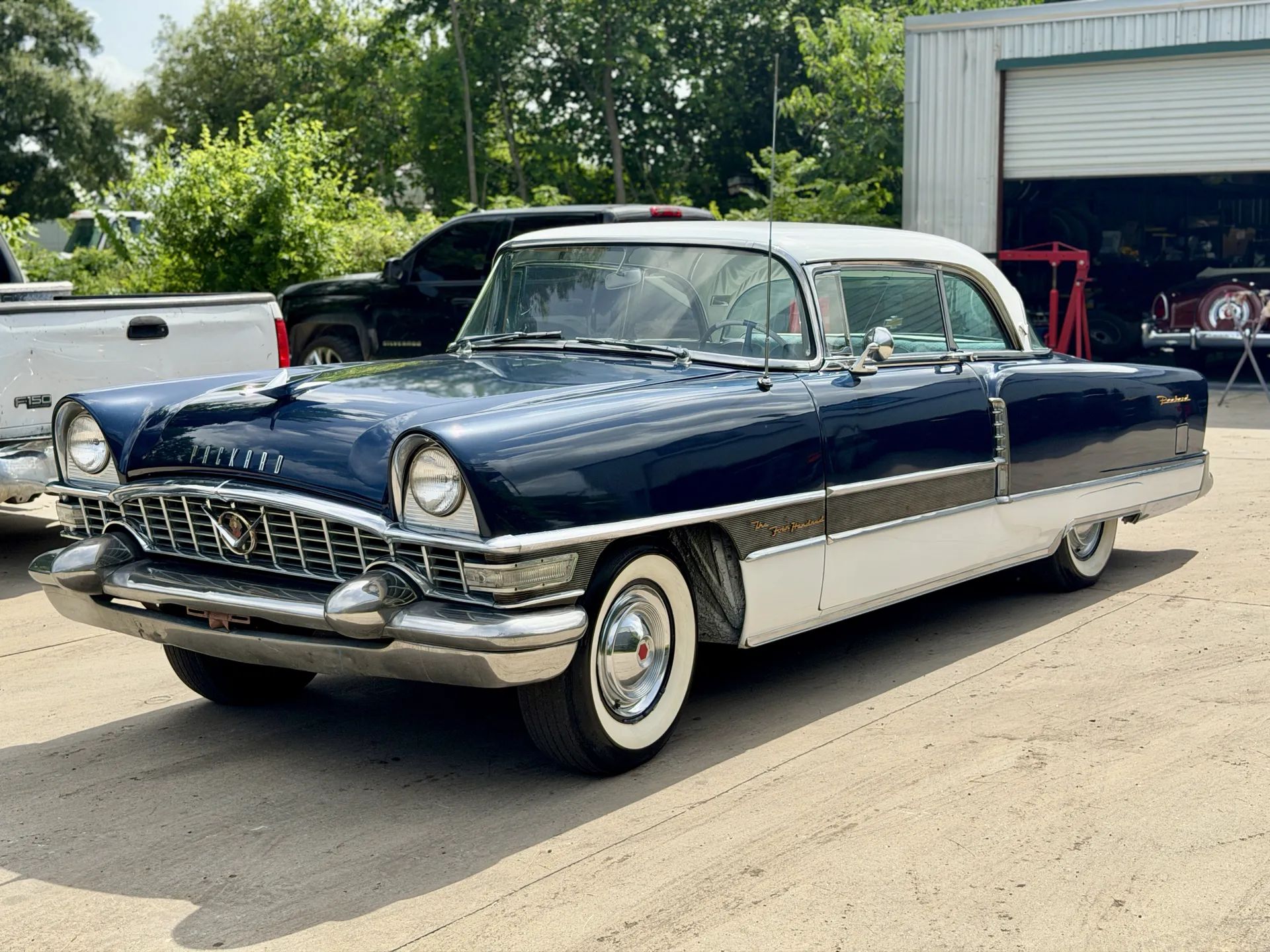 1955 Packard Four-Hundred For Sale: A No-Reserve Driver That "Could Definitely Use Some TLC" 1 Driver front three-quarter view of blue and white 1955 Packard 400
