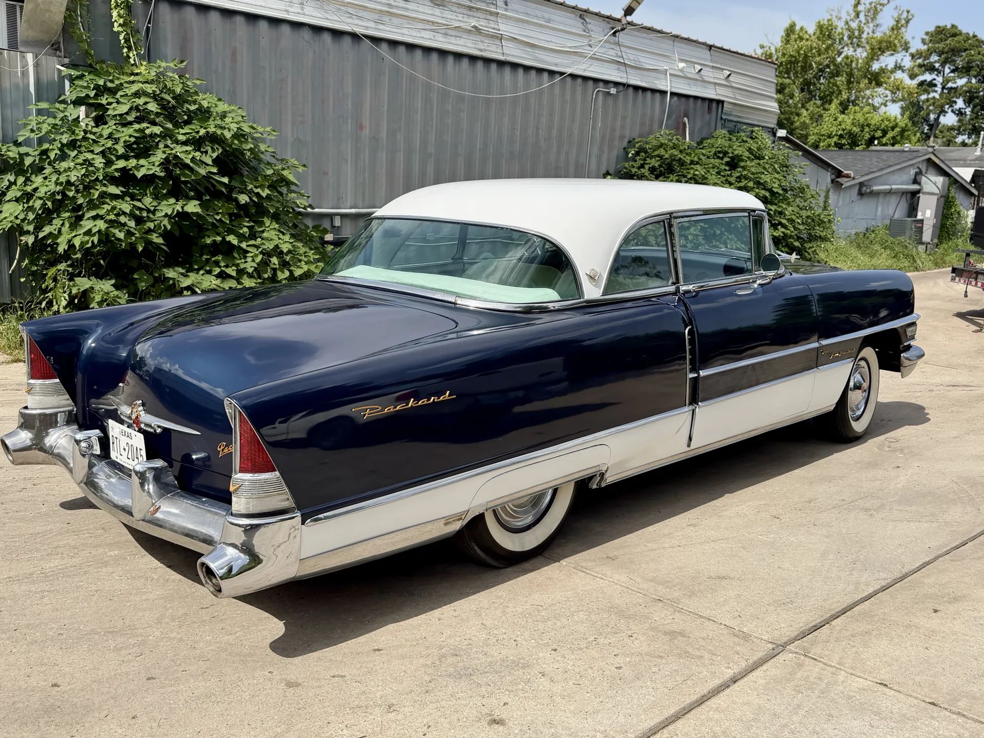 1955 Packard Four-Hundred For Sale: A No-Reserve Driver That "Could Definitely Use Some TLC" 7 Passenger rear three-quarter view of blue and white 1955 Packard Four Hundred