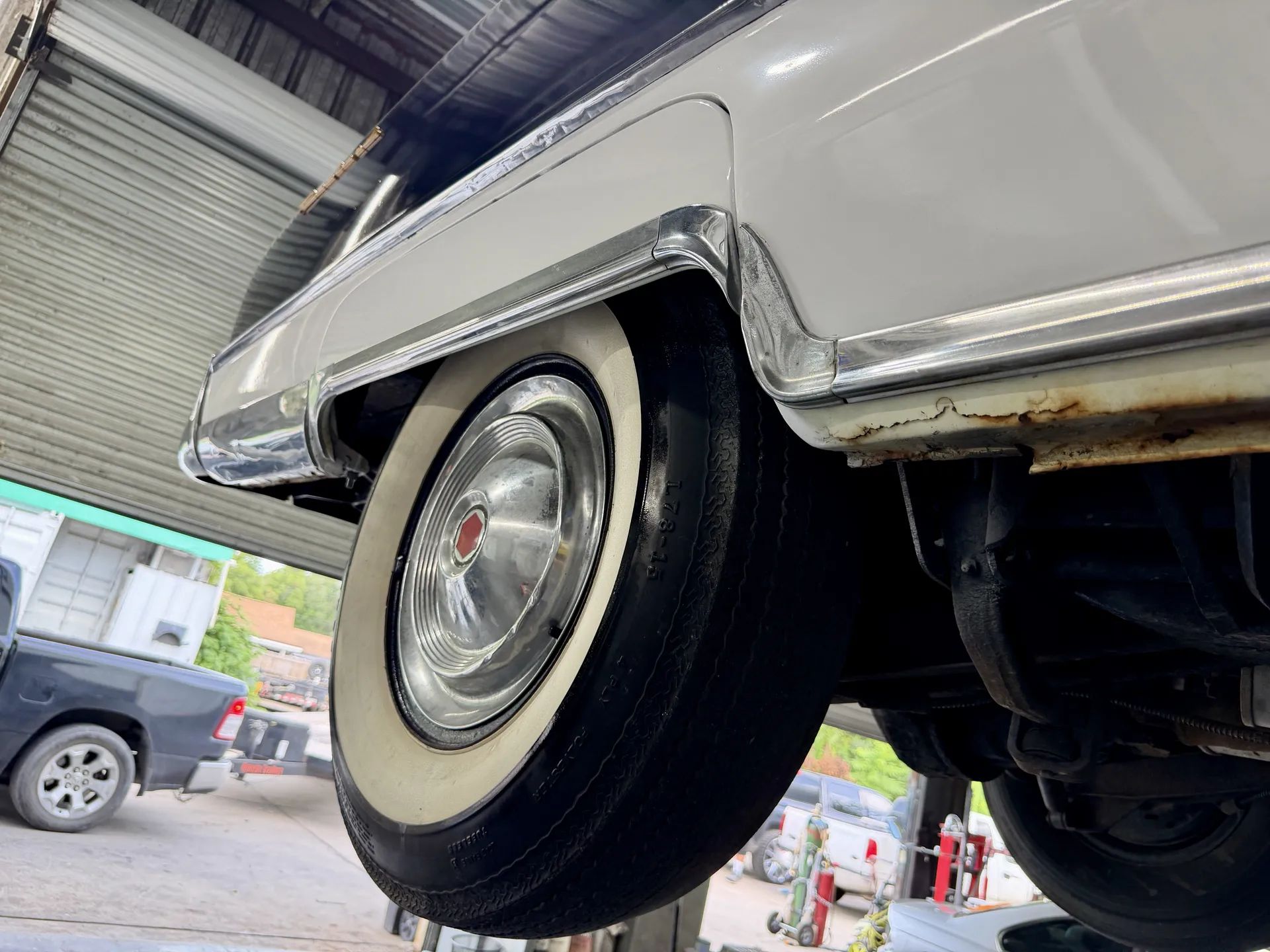 1955 Packard Four-Hundred For Sale: A No-Reserve Driver That "Could Definitely Use Some TLC" 6 Passenger rear wheel and rocker panel of blue and white 1955 Packard 400
