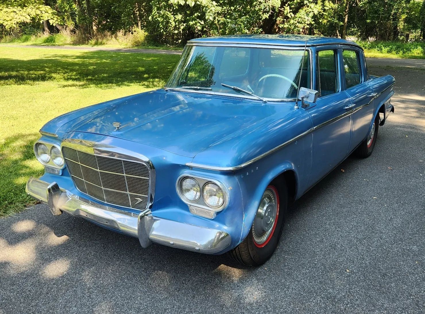 Driver front three-quarter view of blue 1962 Studebaker Lark Sedan