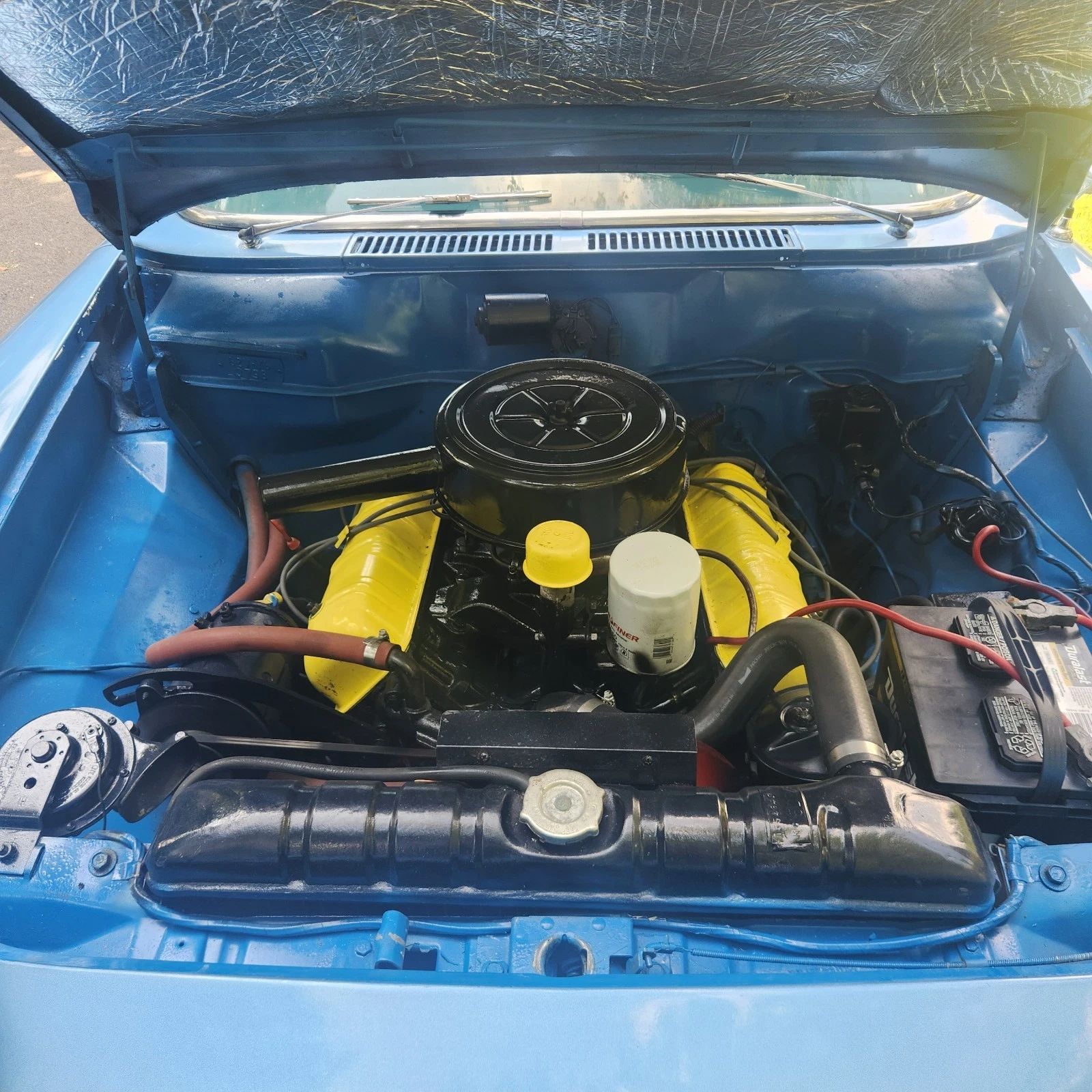 Engine compartment of blue 1962 Studebaker Lark with 259-cubic-inch V8