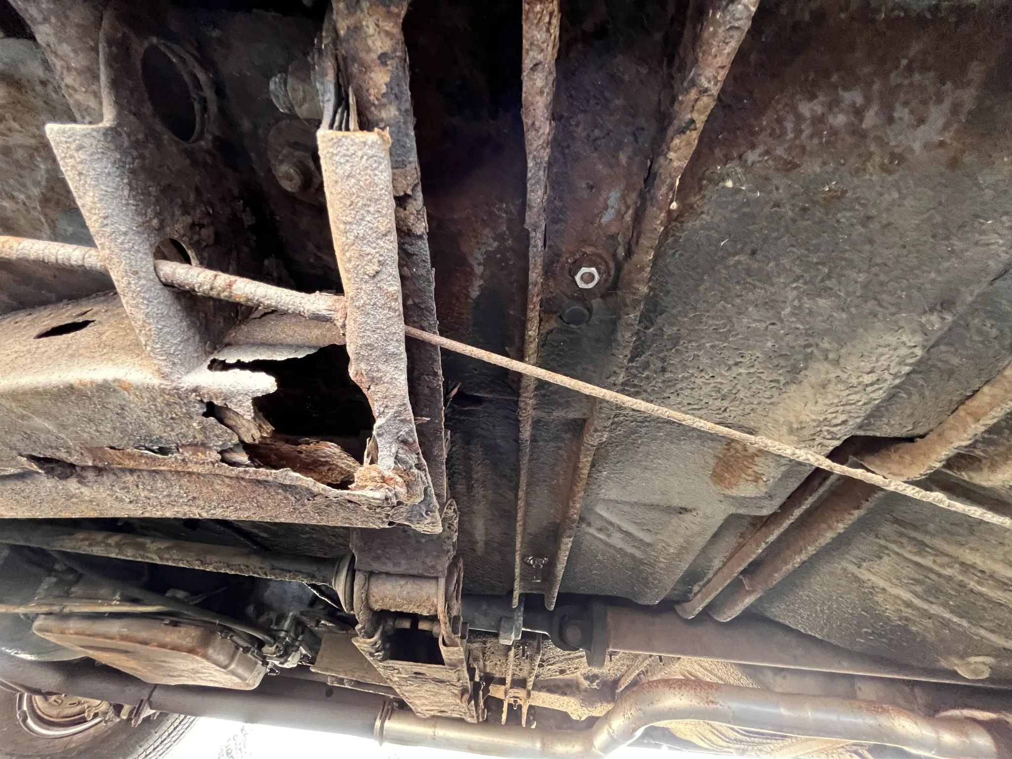 Undercarriage of white 1965 Plymouth Sport Fury Convertible