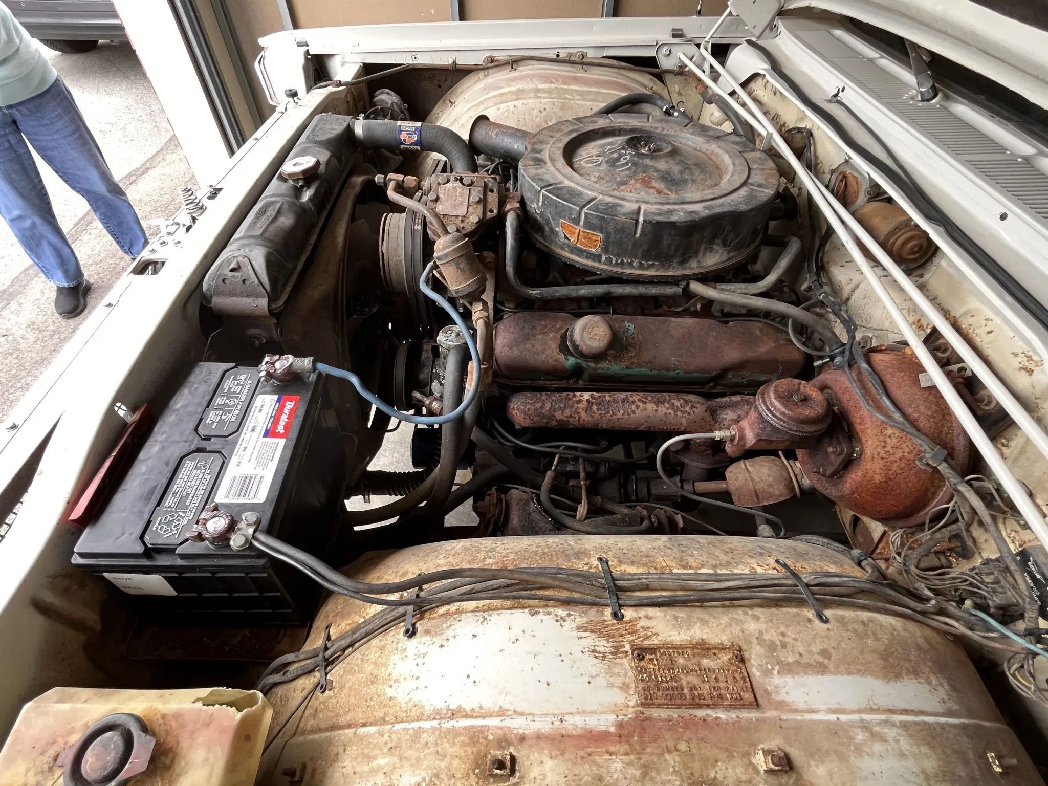 Engine compartment of white 1965 Plymouth Sport Fury with 383 engine