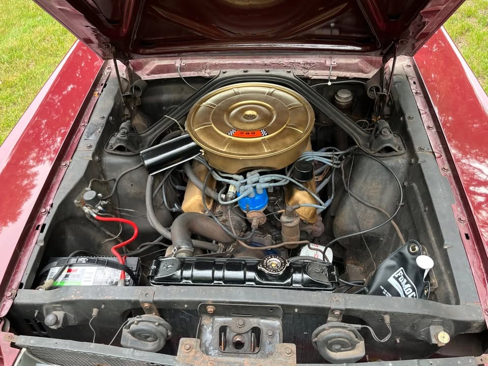 Engine compartment of burgundy 1965 Ford T5 with 289-cubic-inch V8