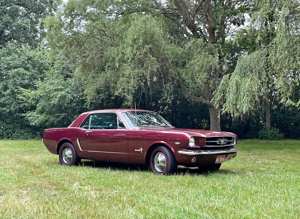 Passenger front three-quarter view of 1965 Ford T5 in burgundy