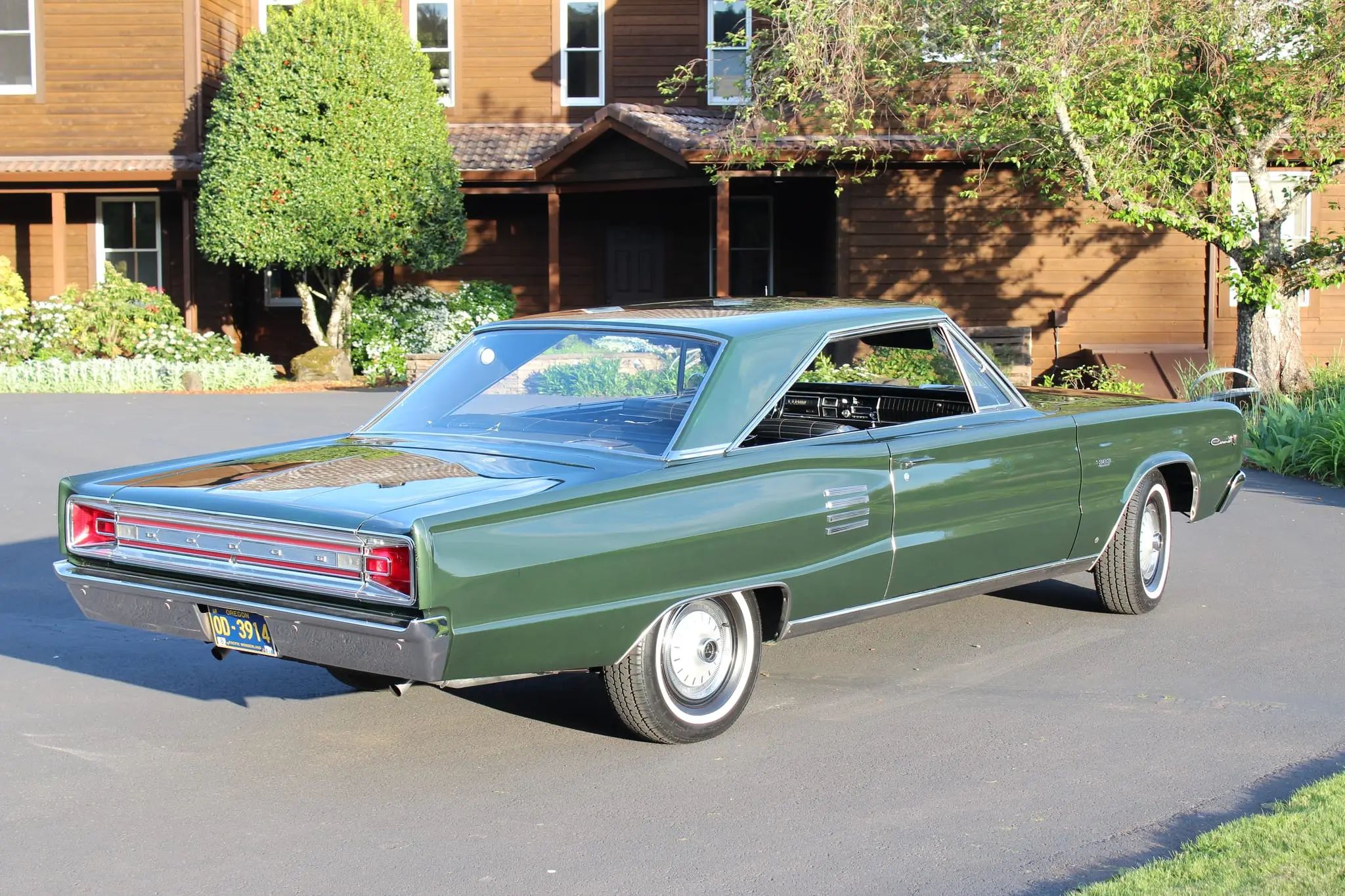 Passenger rear three-quarter view of dark green 1966 Dodge Coronet