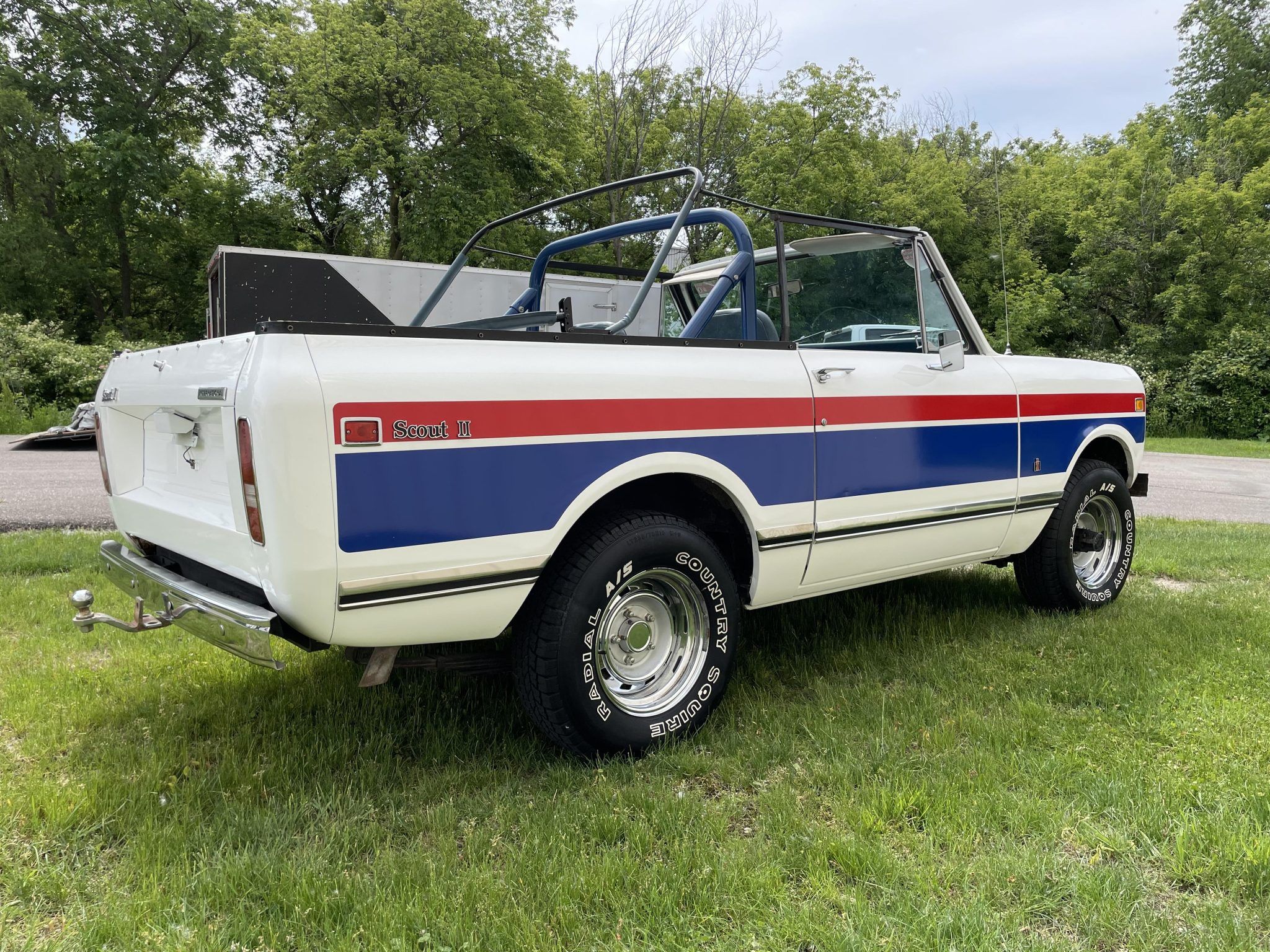 Low angle passenger three-quarter view of white 1976 International Scout II Spirit of '76