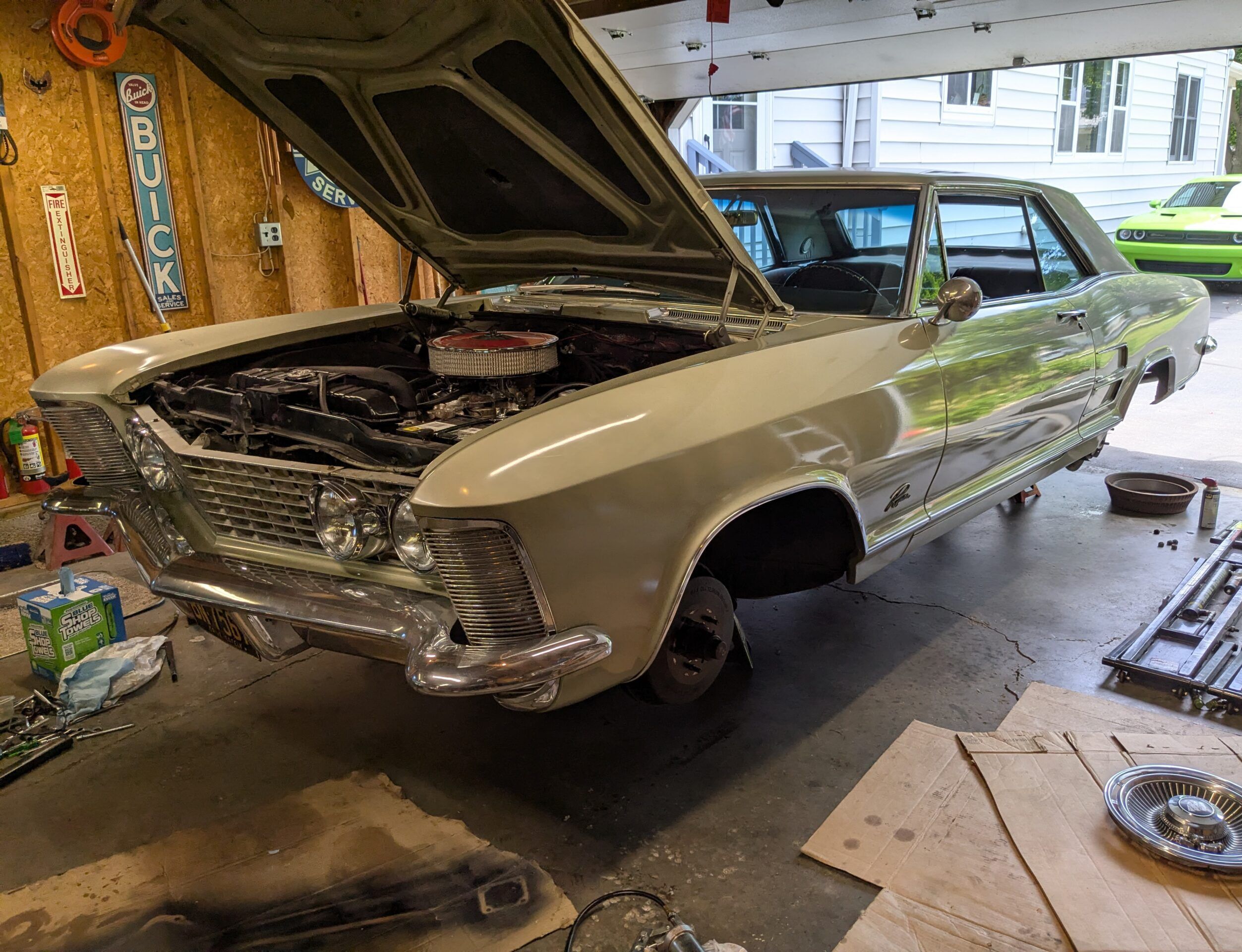 1963 Buick Riviera: All The Maintenance The Factory Recommended (And My Modern Maintenance Schedule) 1 Driver front three-quarter image of gold 1963 Buick Riviera on jack stands in a garage