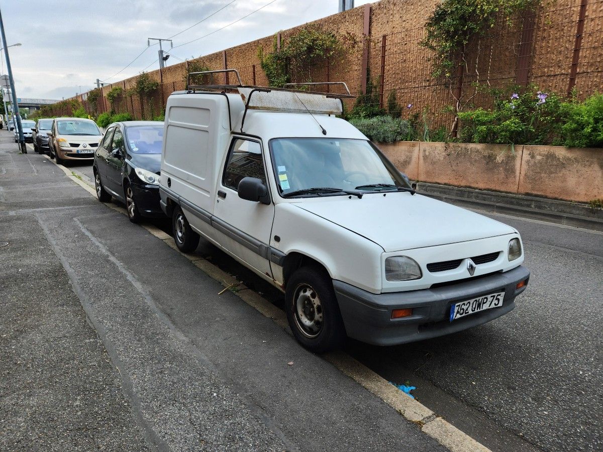 Renault van in front of wall.