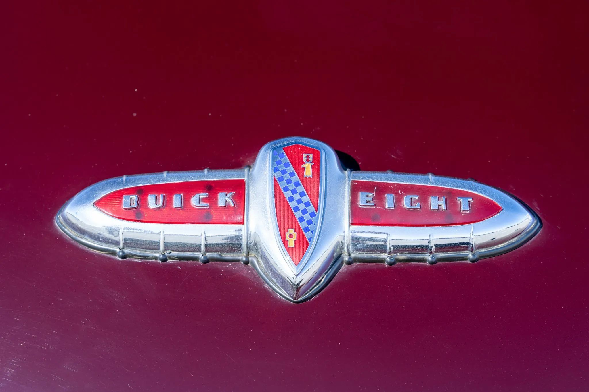 How Buick Became The First U.S. Make With Standard Turn Signals, Almost 20 Years Before They Became Universal 20 Decklid "BUICK EIGHT" emblem on a maroon 1941 Buick